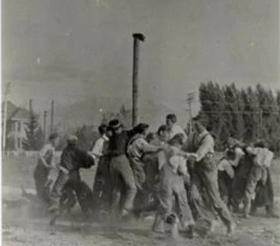 Lehi boys playing "rush the flag" in current day Wines Park, sometime between 1915-1916. The John Y. Smith house can be seen on the left.