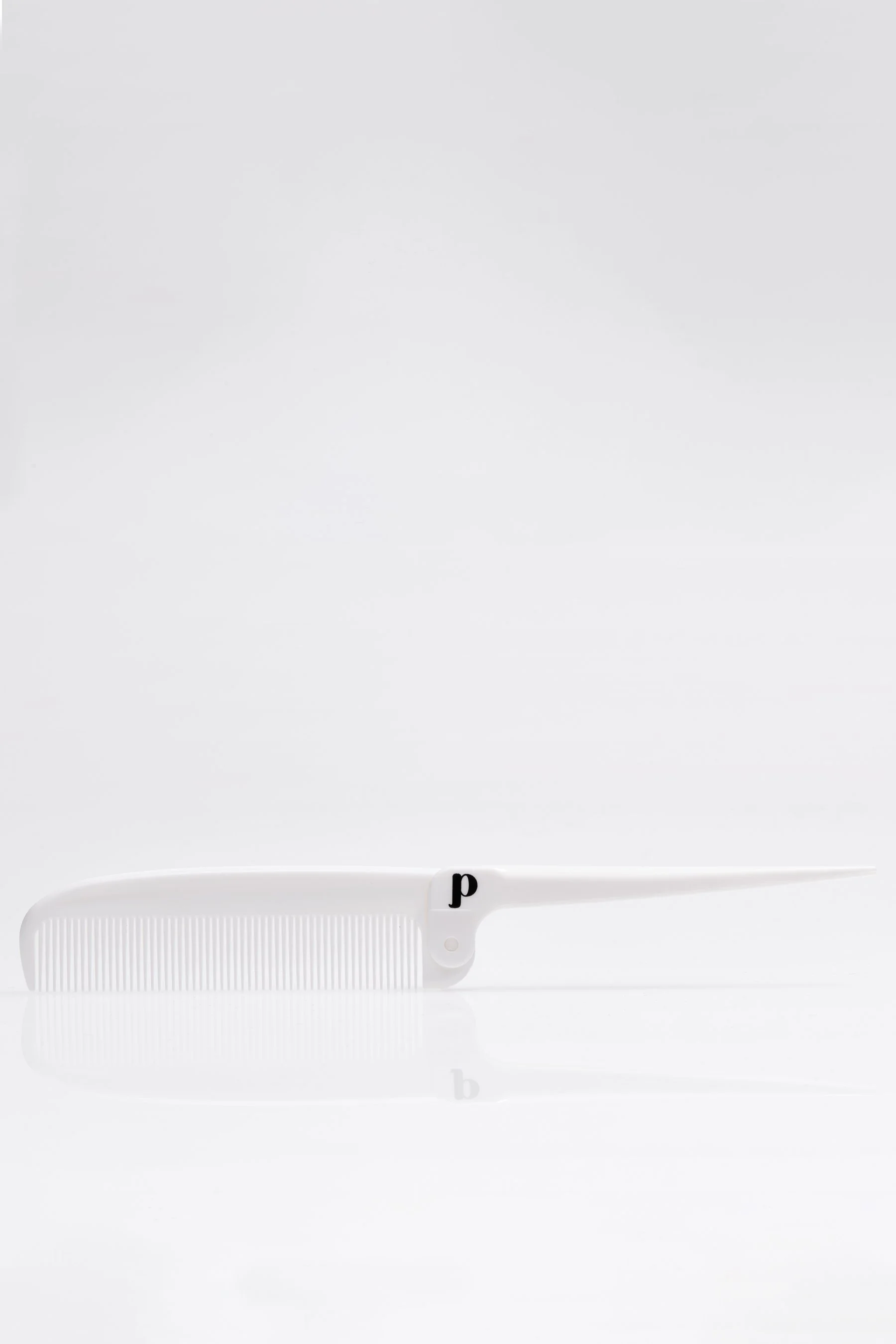 Folding rat tail comb for styling pixie cuts.