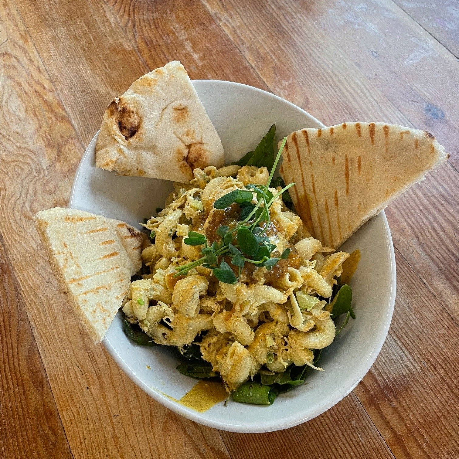 I was so excited about the new May special I couldn't wait until lunch time to order it!!
Chef Kara has concocted a creamy and delicious curried chicken pasta salad, served on a bed of local greens, alongside naan points and her homemade mango chutn