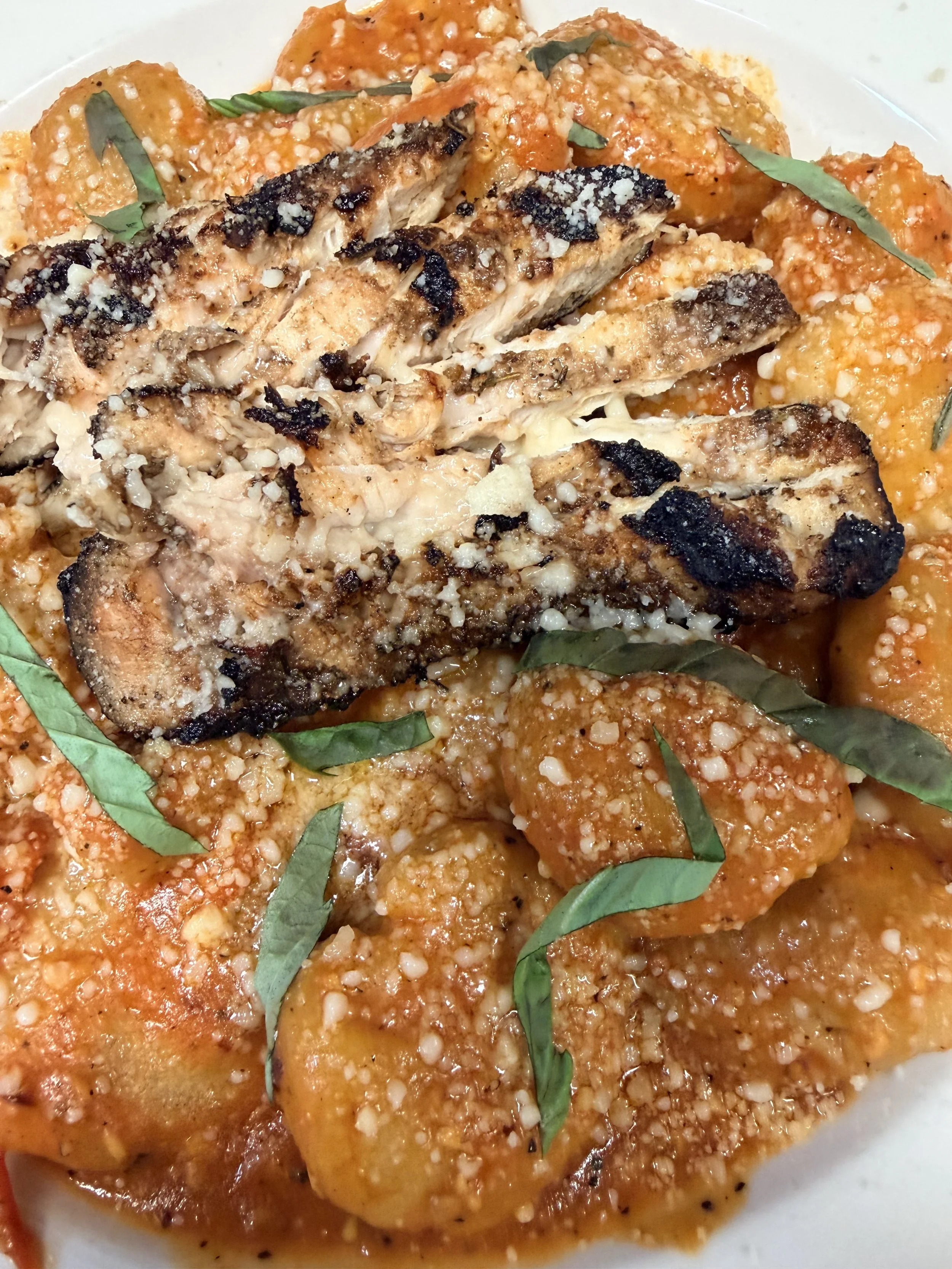 Homemade Gnocchi, topped with grilled chicken and tossed in a pomodoro sauce
