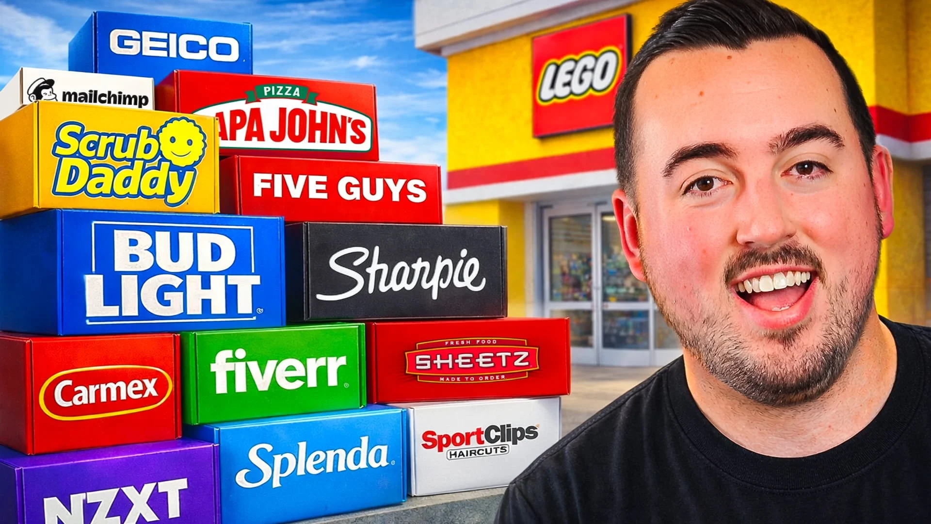  Matt Philie standing in front of a stack of boxes with various brand logos, outside a store. The boxes include brands such as GEICO, mailchimp, Scrub Daddy, Papa John's, Five Guys, Bud Light, Sharpie, Fiverr, Sheetz, Splenda, and Sport Clips.