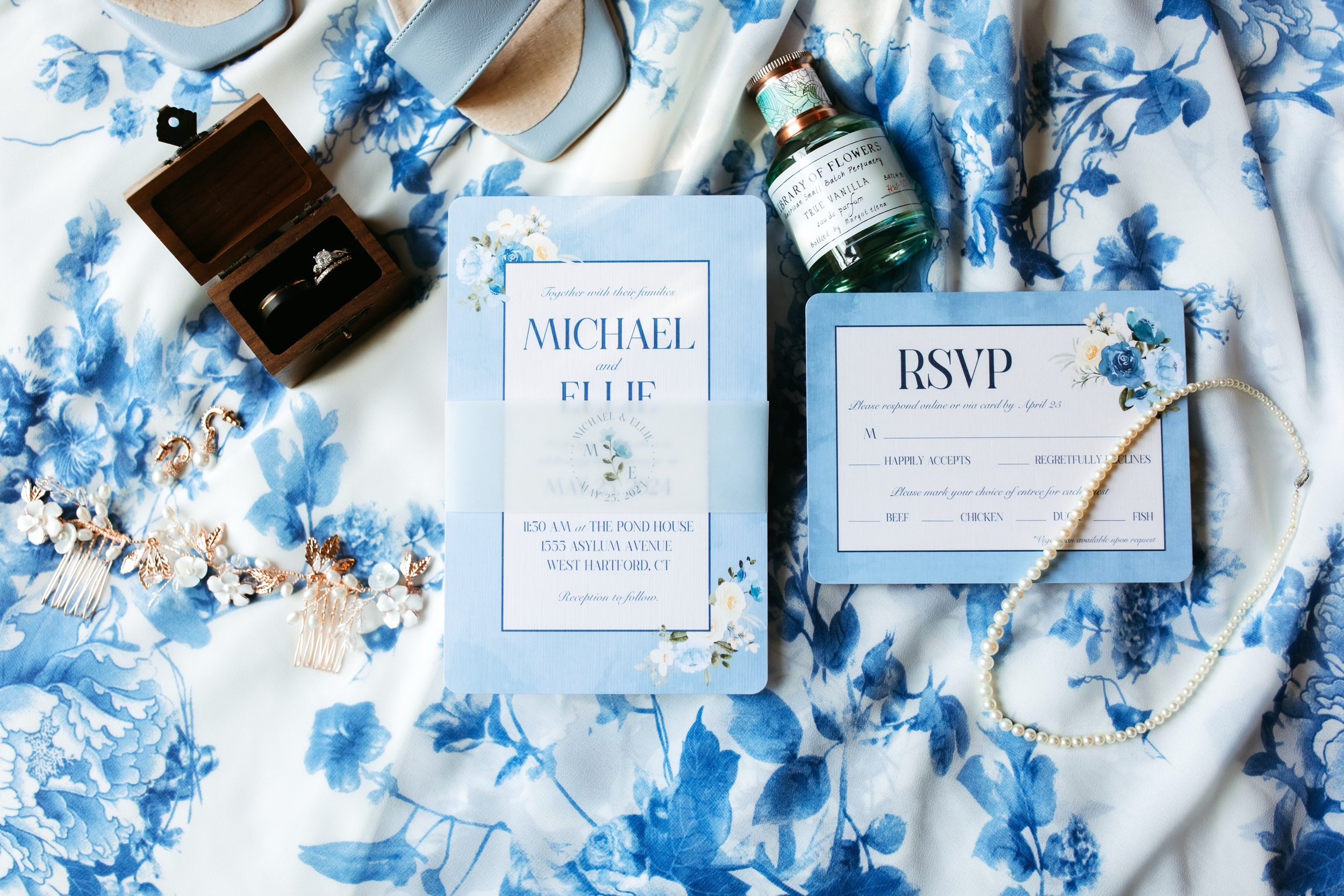 Photo of a wedding invitation and wedding RSVP note desgined in an elegat style with painted roses and elegant typography. Designed by Will Lefkovich