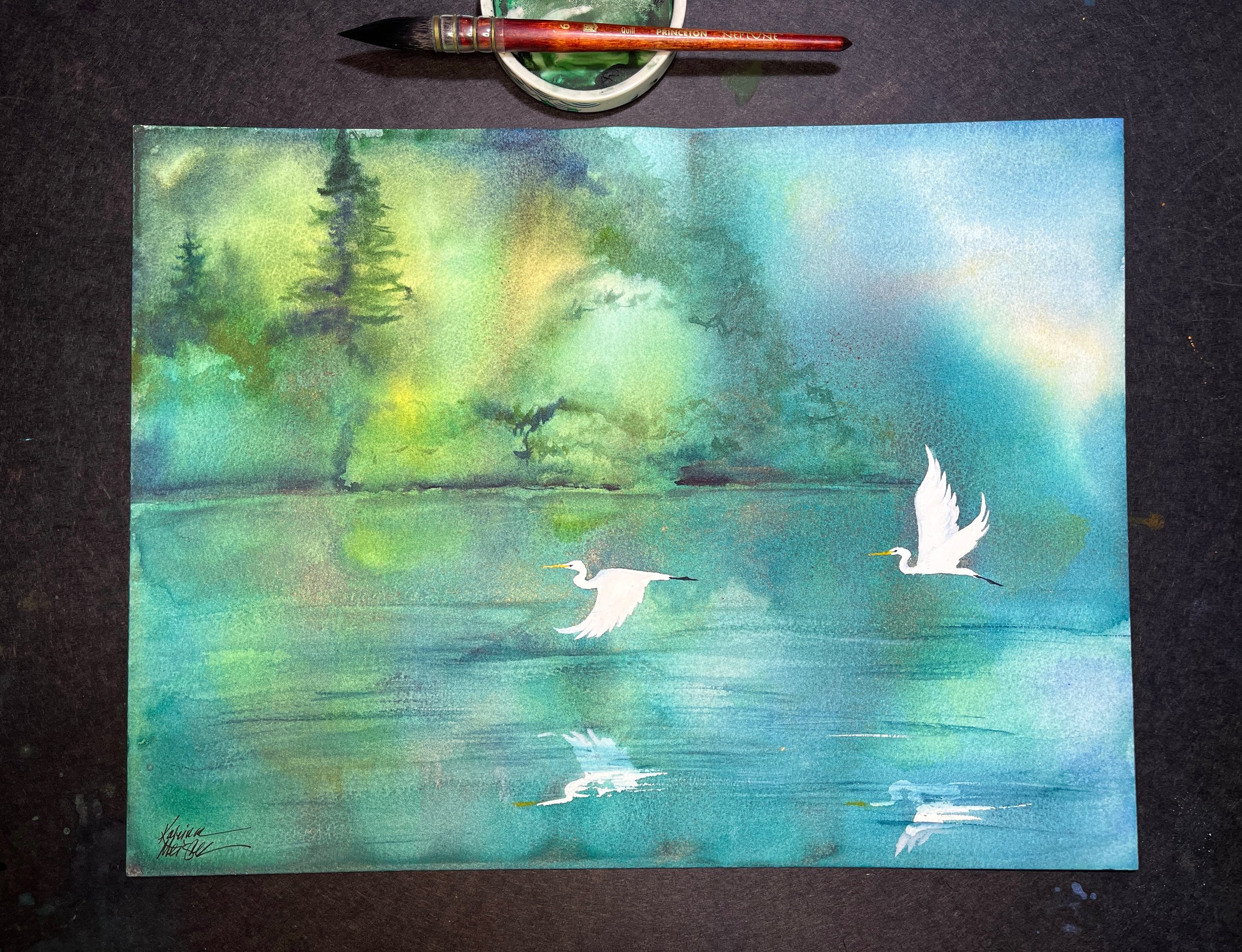 Katrina-Meister-Evergreen-Reflections-watercolor-painting-egrets-desk-shot.jpeg