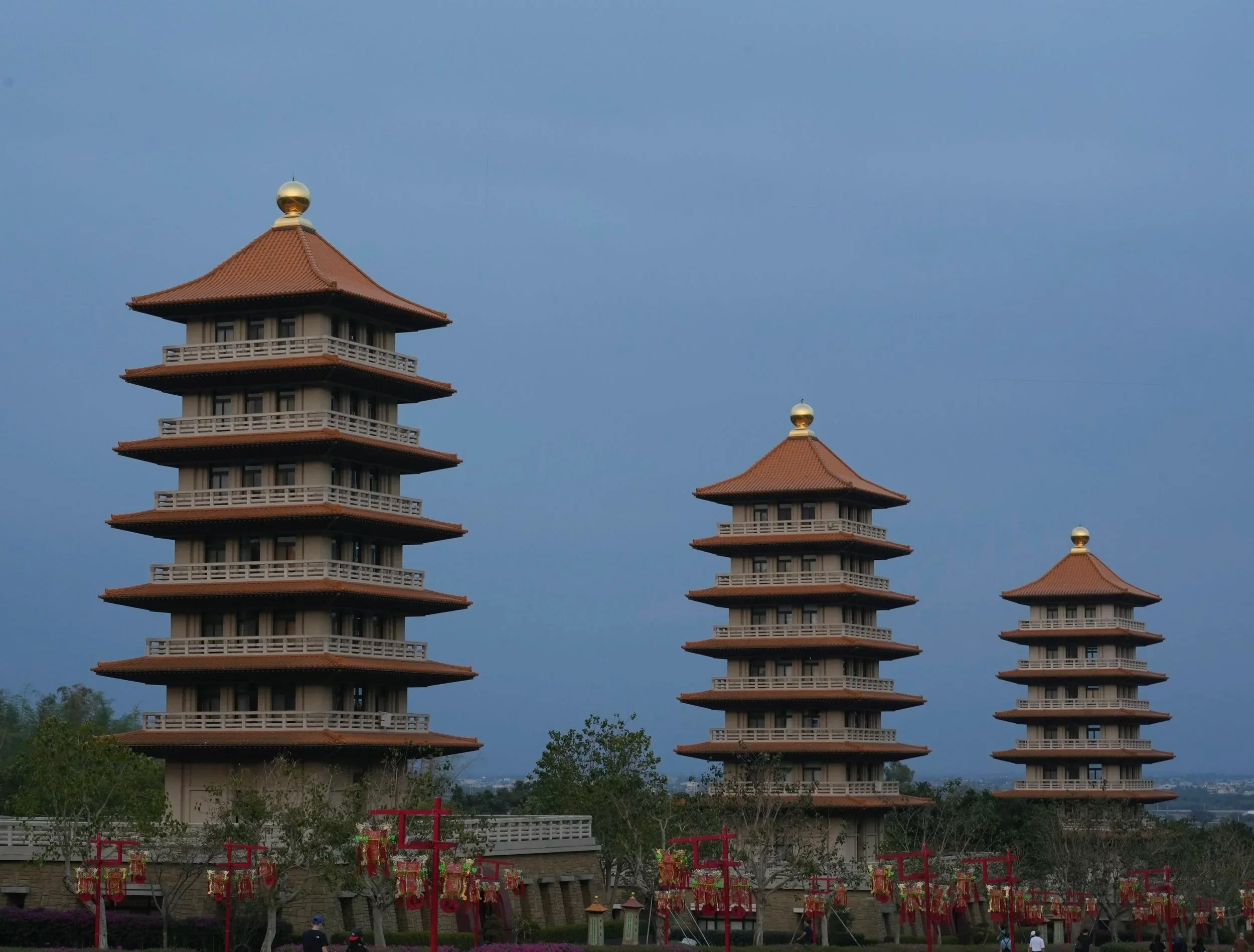 Jade's camera captures Fo Guang Shan's pagodas illuminated by blue hour sky. 