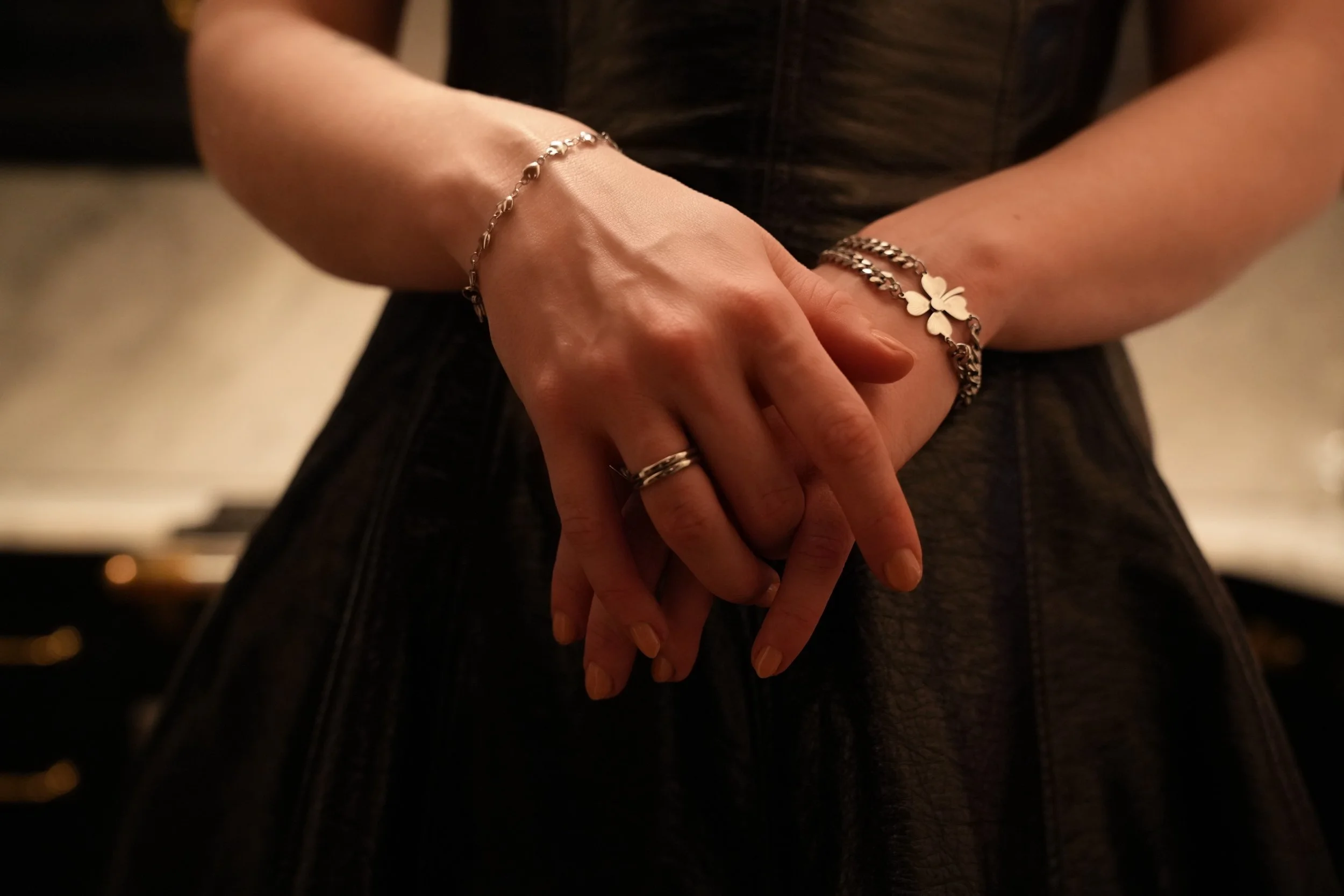 Jade's hands are placed in front of the camera, showing two bracelets she made. 