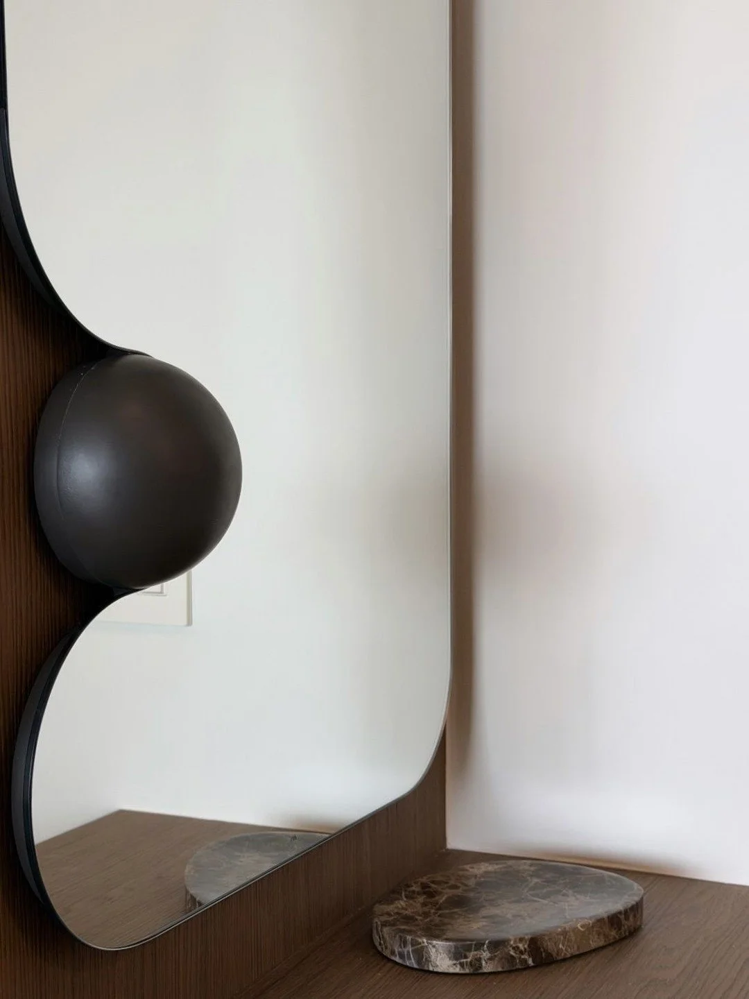 // DOUBLE TAKE - obsessed with this sculptural mirror we sourced for our L.I.C. Luxury Condo project - those beautiful black orbs against the oak millwork are doing exactly what we hoped they'd do - mirror by @_readytohang &amp; design by #clairehung