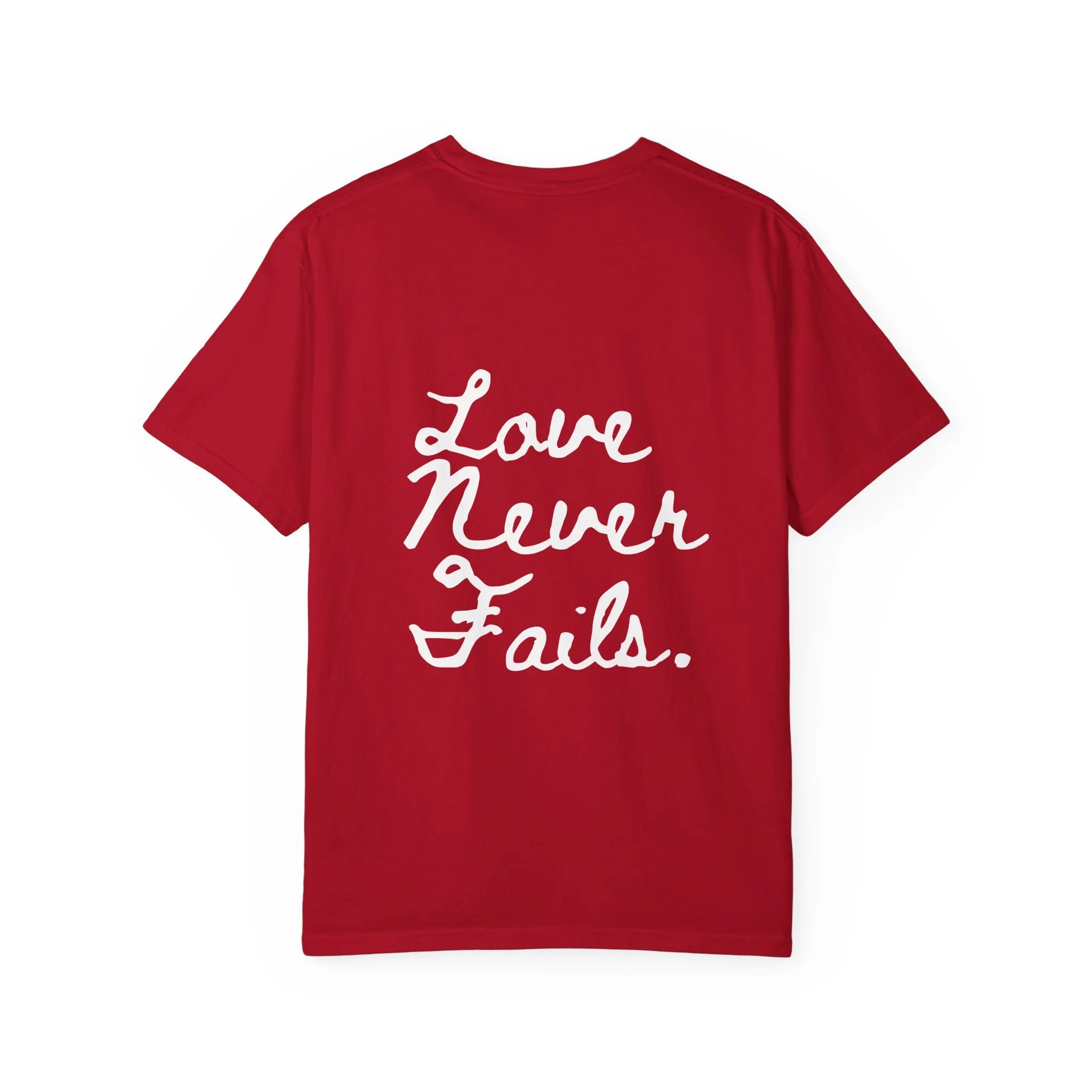 Love Never Fails script on a mustard garment-dyed tee