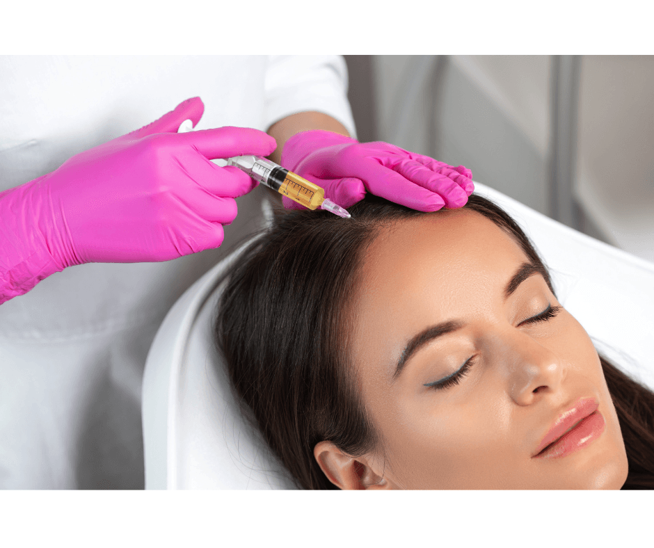 A woman receiving a cosmetic injection in her forehead from a healthcare professional wearing pink gloves.