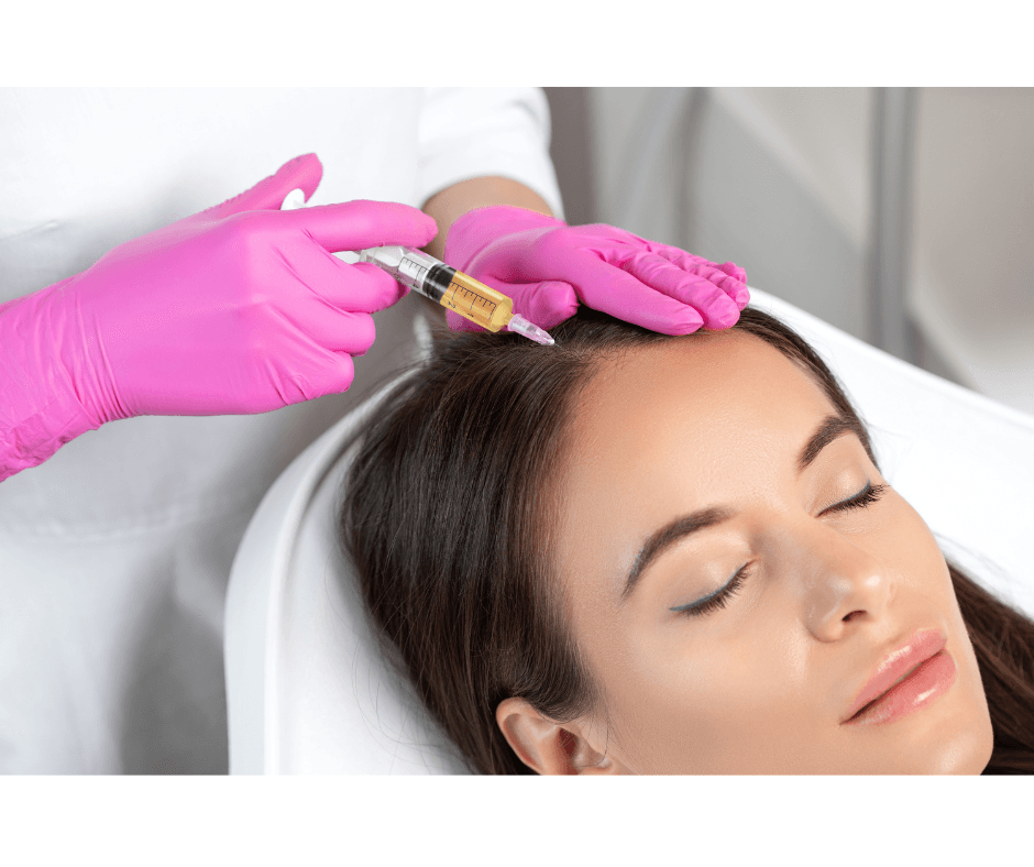 A woman receiving an injection in her forehead from a healthcare professional wearing pink gloves.