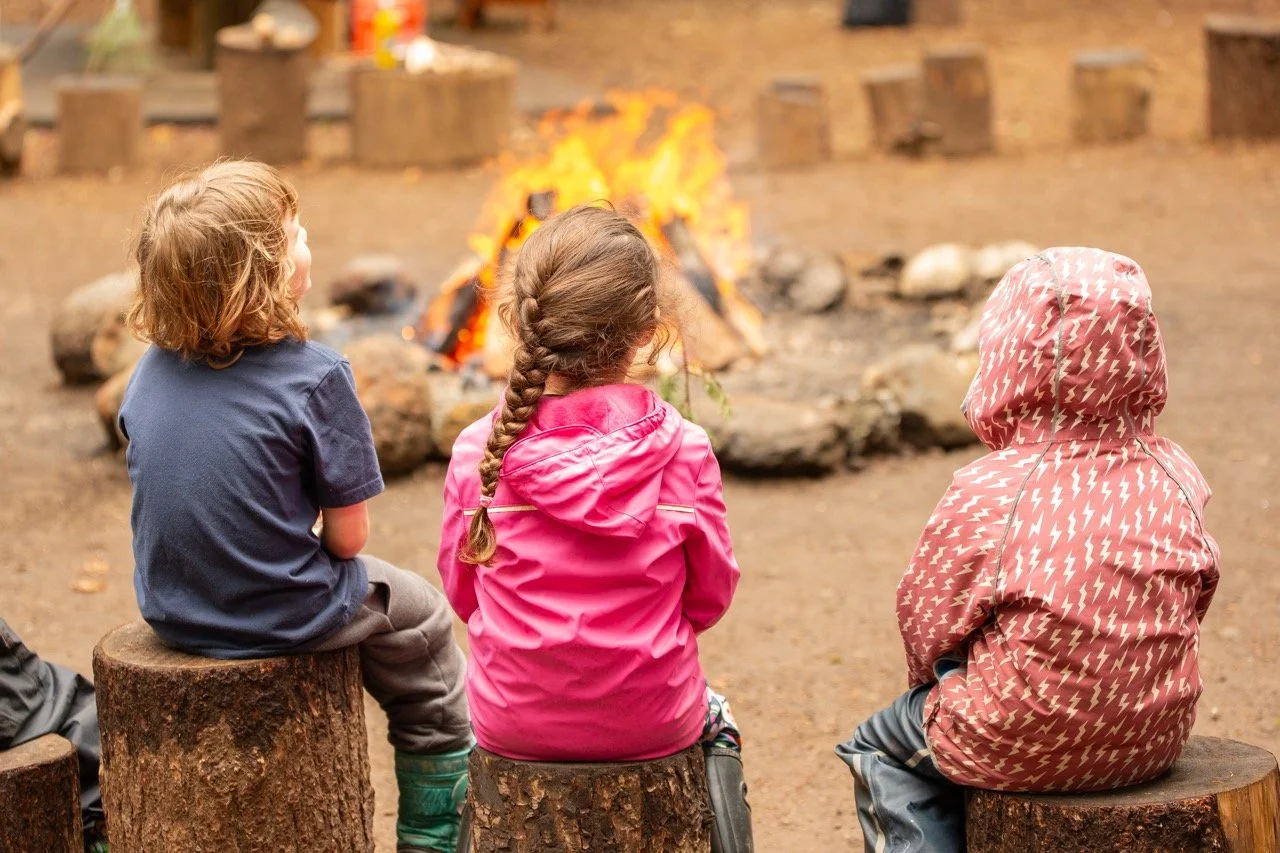 Outdoor school students around a camp fire. Portland private school, nonprofit, alternative education- The Portland Forest School a community based, low ratio, elementary and middle school. 
