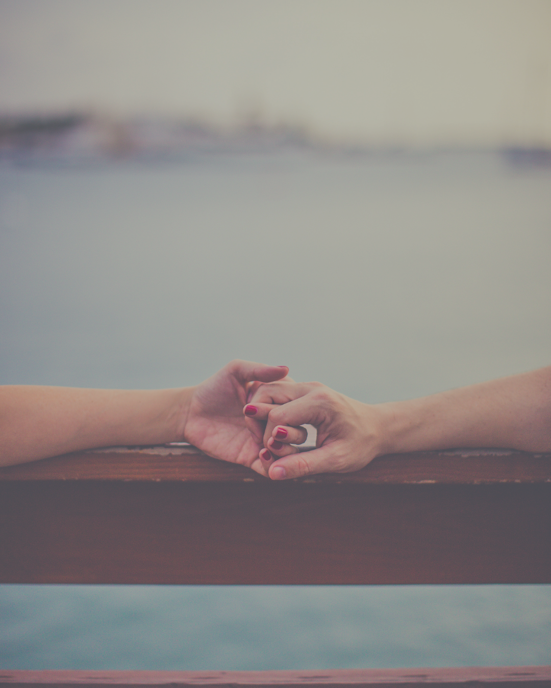 2 persons holding hands supporting each others