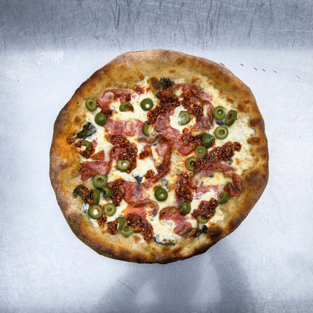 🍕 We made a new pizza that is the warmth of our hearth in the heart of winter! 

&quot;The Basil Burrata Pizza&quot; - Soppressata salami, Castelvetrano olives, and crushed basil leaves with creamy burrata, mozzarella, white cheddar, and provolone c