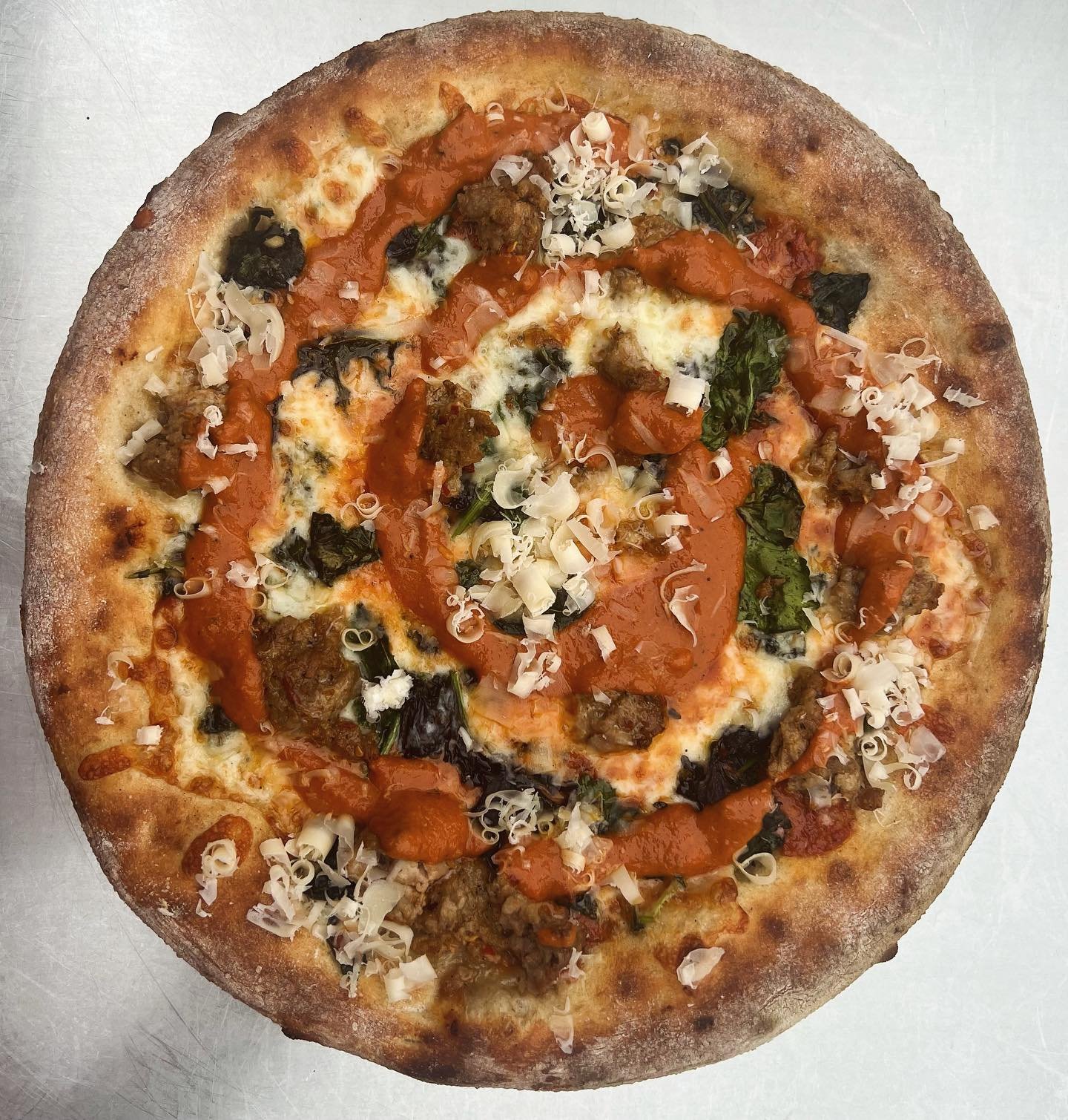We brought back a fan favorite for our January pizza!

Sausage + Kale alla Vodka Sauce 🤌🏼
Mozzarella, white cheddar and provolone cheeses with our house made pork sausage. Topped with kale two ways and finished with freshly grated American Grana an