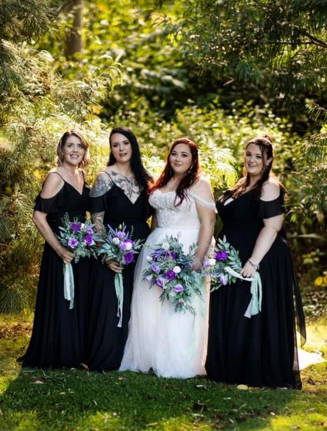 bride and bridesmaids holding blue bouquets