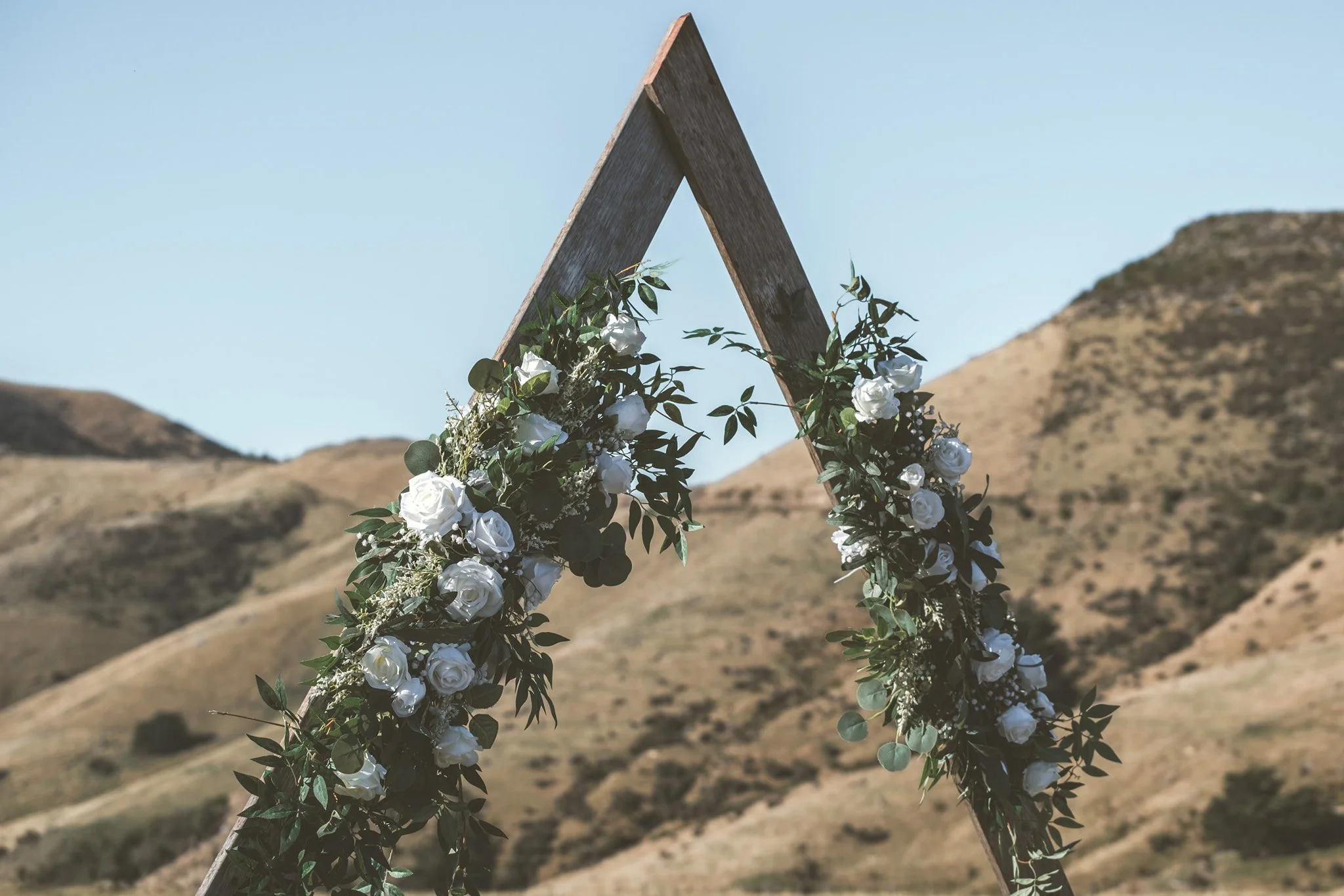 modern white floral décor for triangular arch 