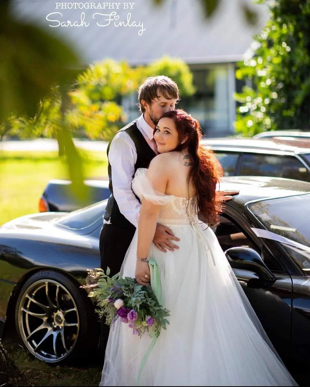 newlywed portraits next to supercar