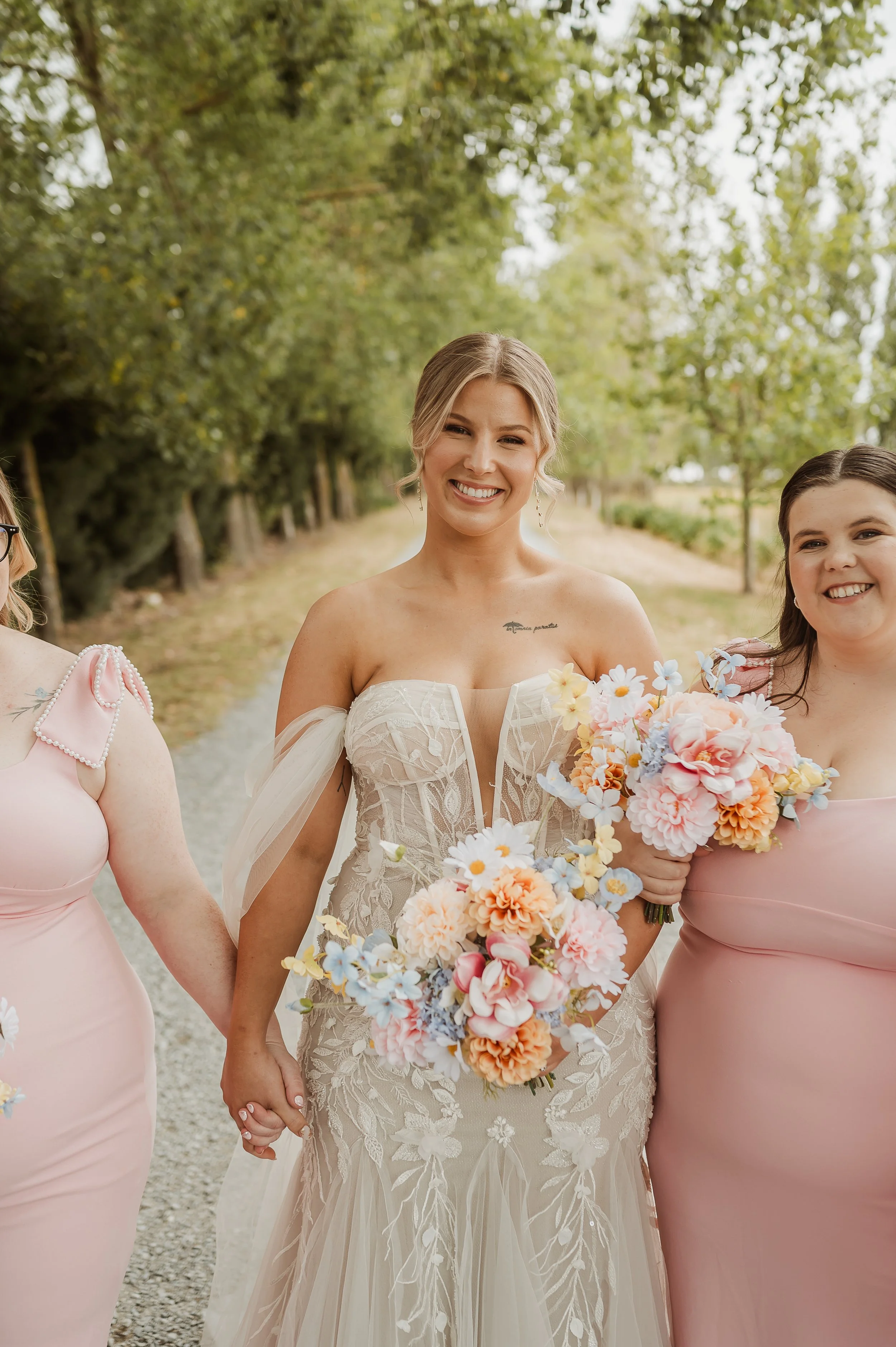 bright and pastel colours for bridal bouquet shown off by bride and bridesmaids