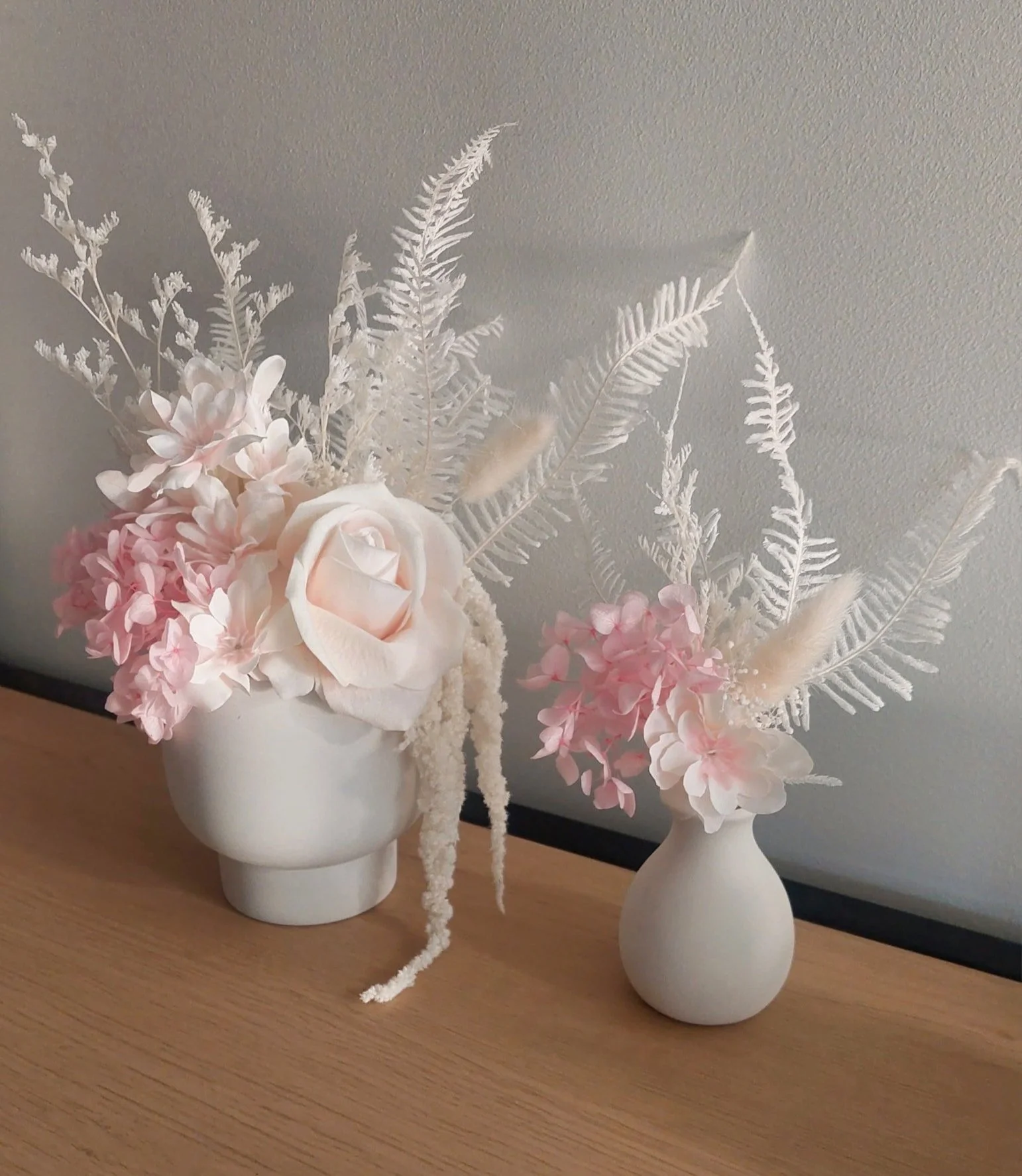 two small cute white and light pink vase arrangements