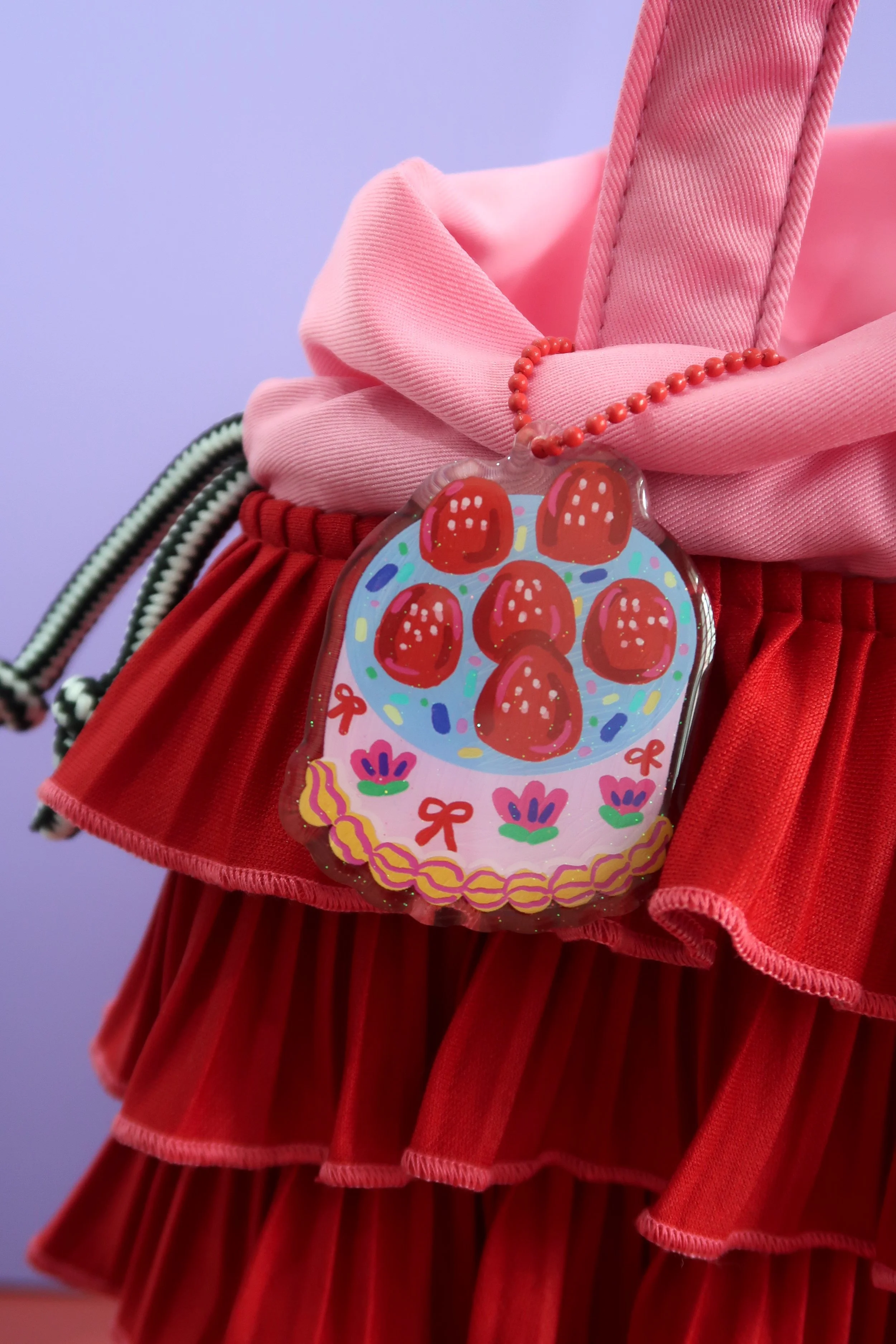 Glitter and rounded acrylic cute cake charm. Approx. 6cm. Suitable for bags, and keychains. Illustrated by Nina Zai in Singapore. The Wrecklessmess.