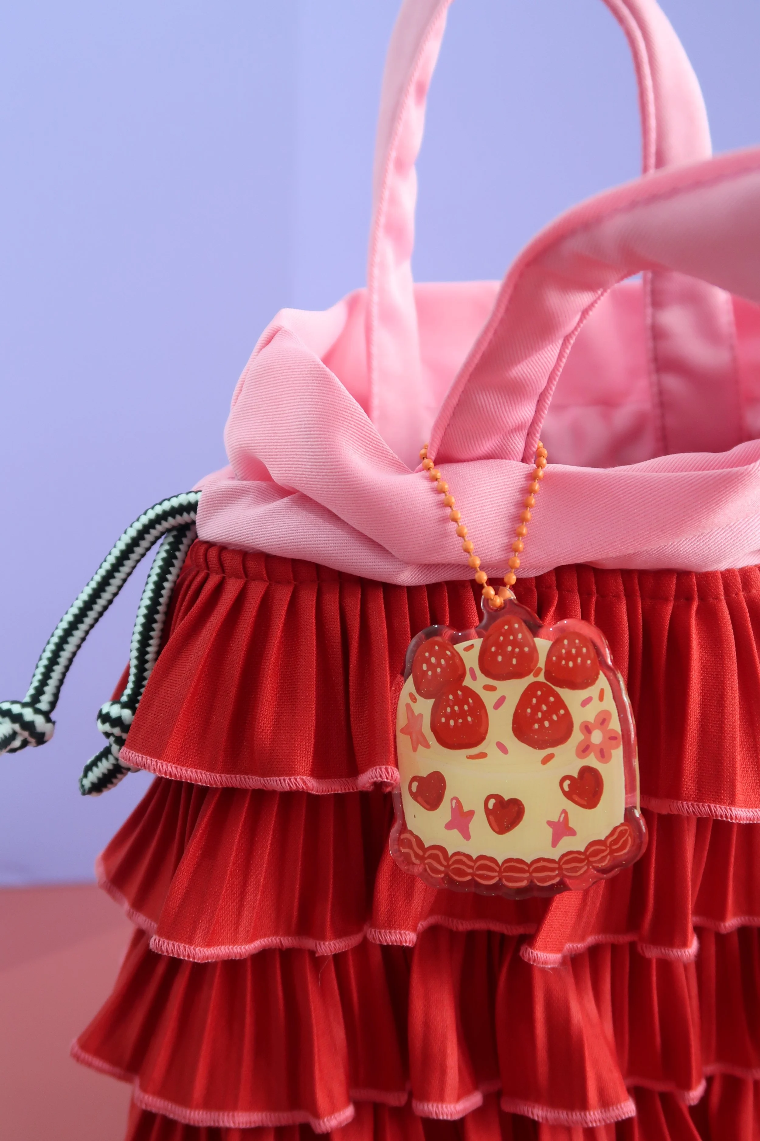 Glitter and rounded acrylic cute cake charm. Approx. 6cm. Suitable for bags, and keychains. Illustrated by Nina Zai in Singapore. The Wrecklessmess.