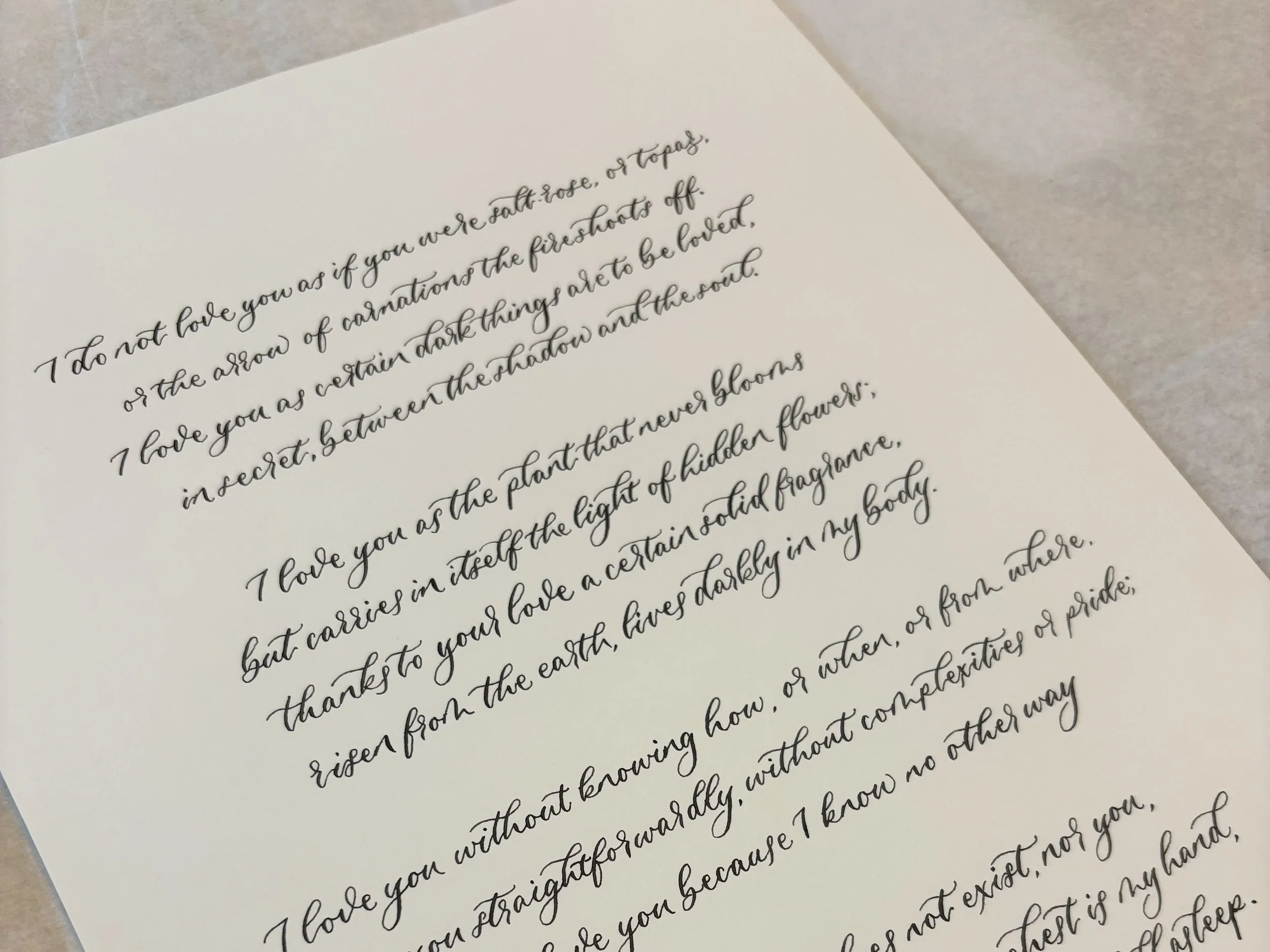 calligraphy commission. A4 sheet of heavy ivory cardstock, finished with black modern calligraphy using a traditional nib and ink. 