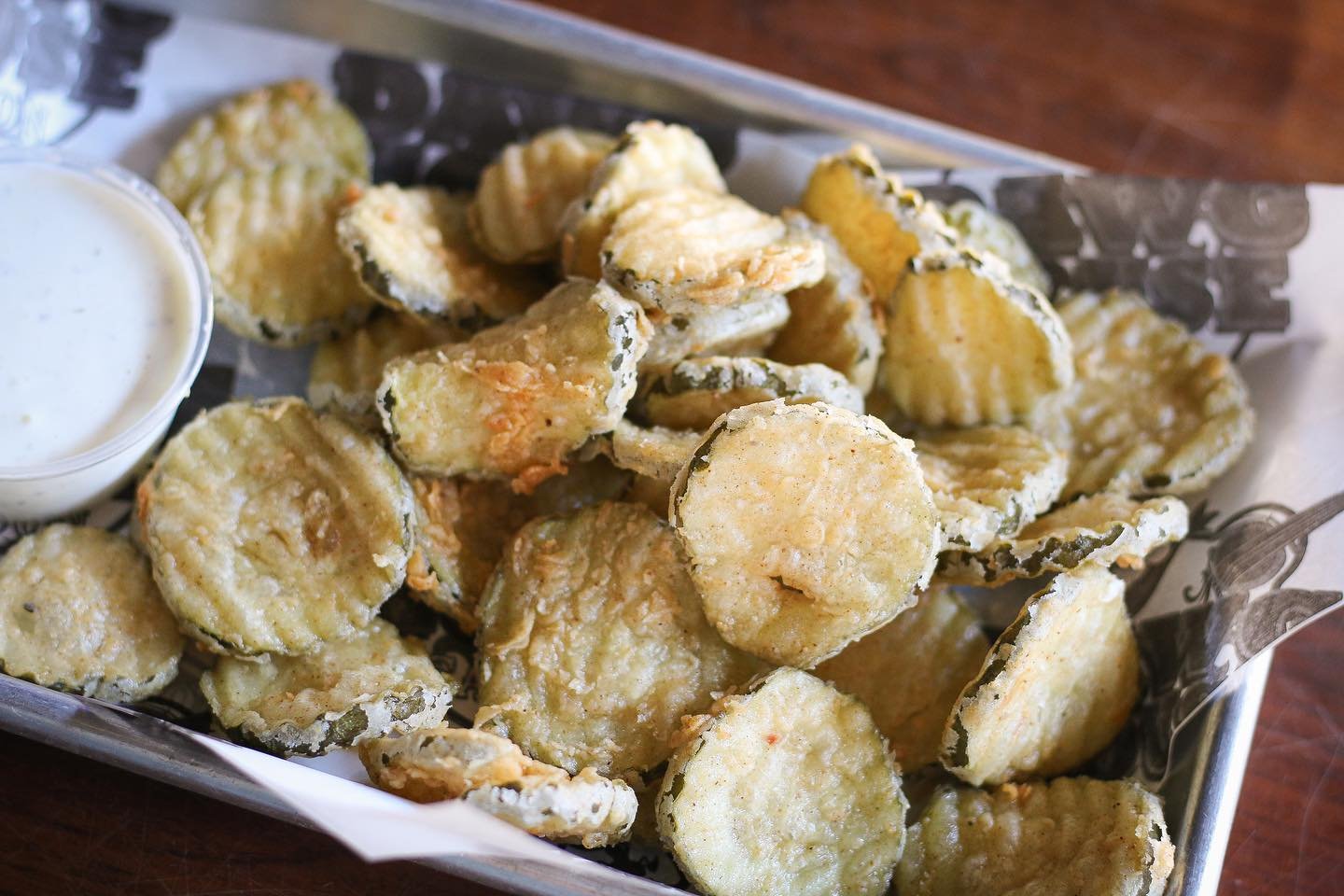 Crunchy, tangy, and downright irresistible! Dive into a basket of our crispy fried pickles at DawgHouse. It&rsquo;s the perfect snack to add some zing to your day! 🥒