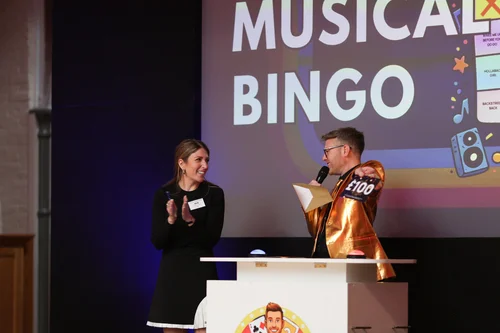 Host handing over the £100 gold envelope in the Show Time Gamble