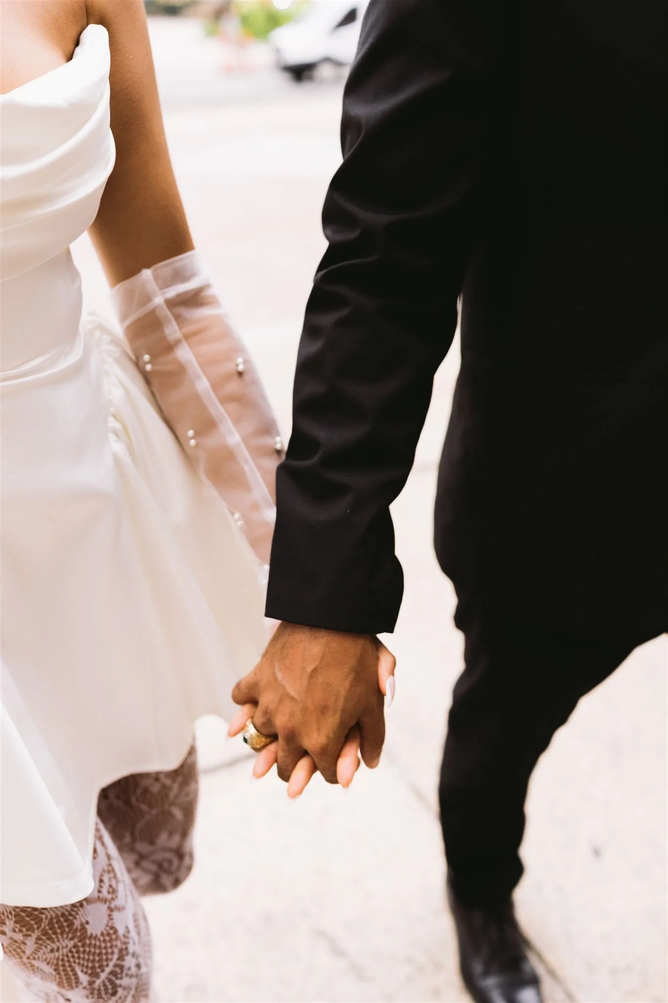 Newly engaged couple holding hands walking through Copley Square in Boston.