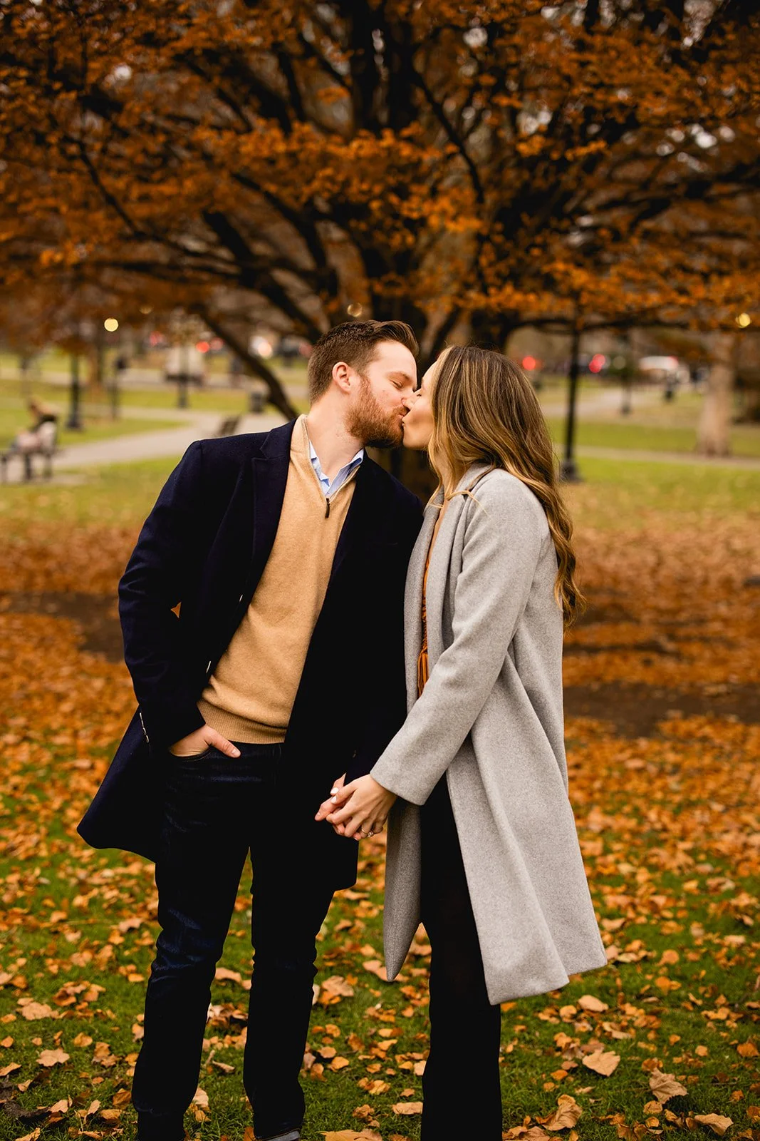 Couple kissing among fall foliage during a Boston Public Garden engagement photo session.