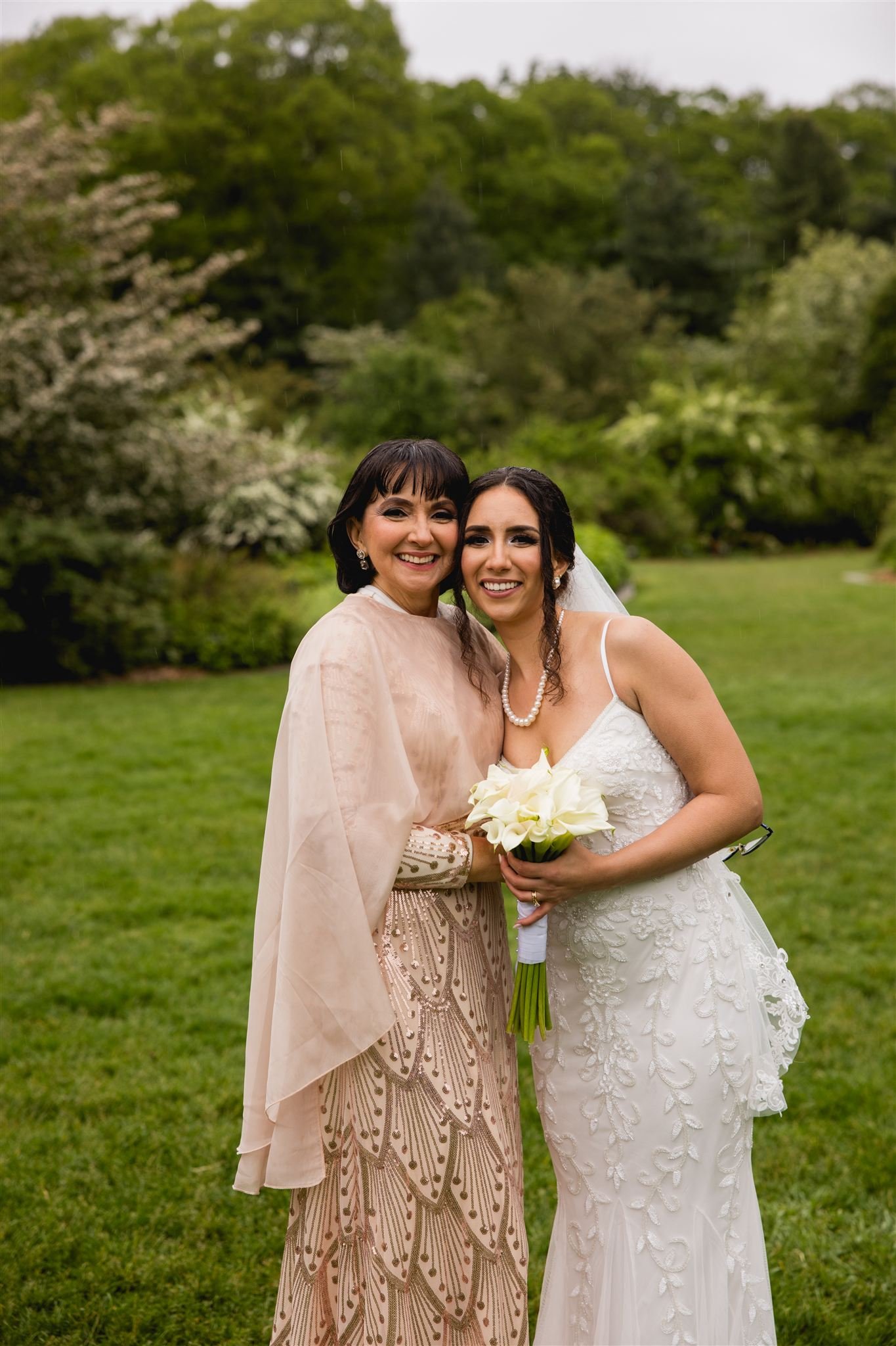 bride and her mother smiling candidly at camera at a micro pop-up wedding at Arnold's Aboretum in Jamaica Plains Boston