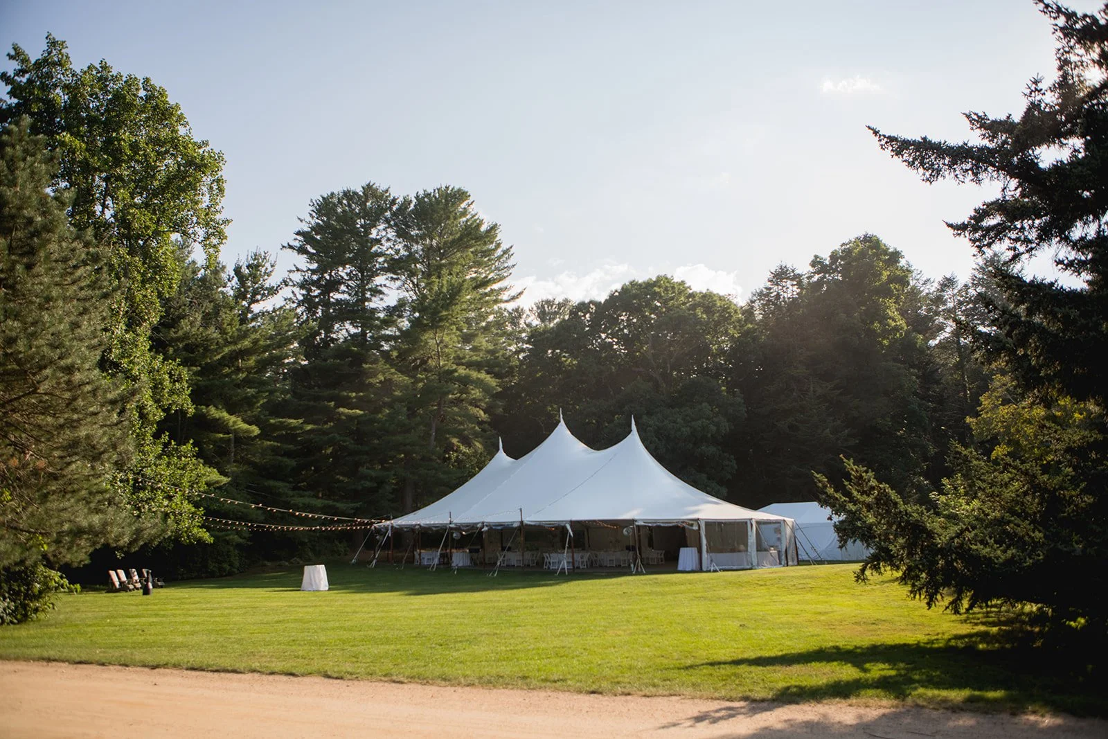 Wedding reception tent set up on the lawn at Estate at Moraine Farm in Beverly, Massachusetts
