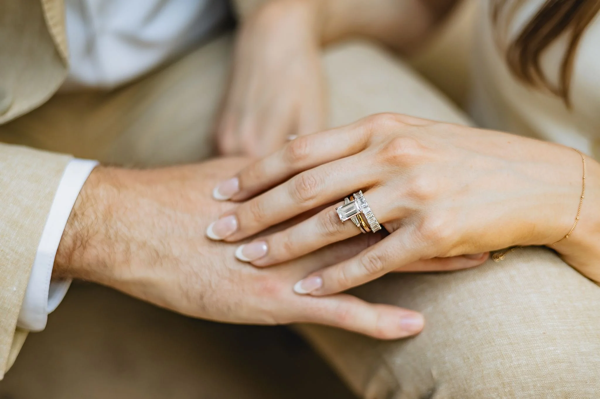 Newly wed bride and groom holding hands and showing off wedding rings after their elopement at Boston City Hall.
