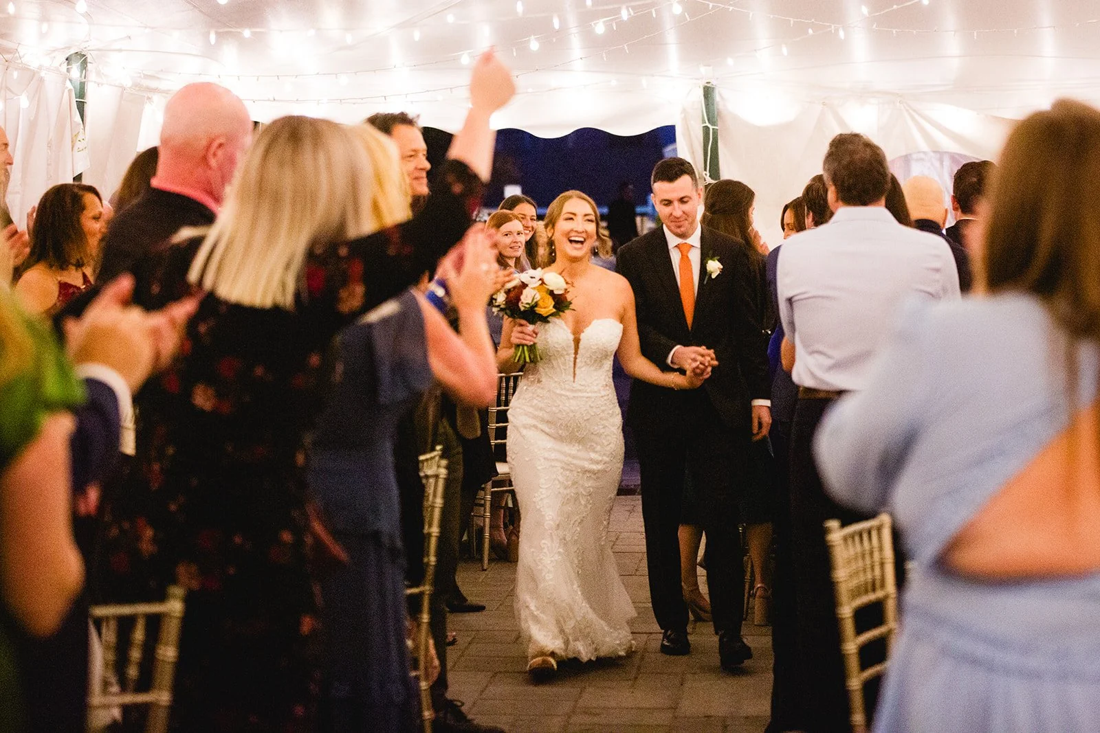 Bride and groom entering wedding reception at Smolak Farms in North Andover Massachusetts