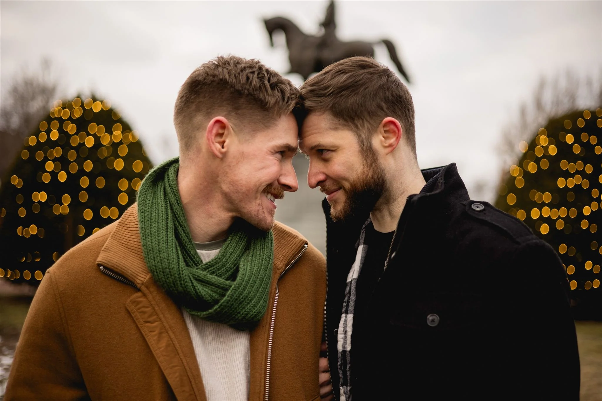 Engaged couple gazing into each other's eyes and smiling in the Boston Public Garden