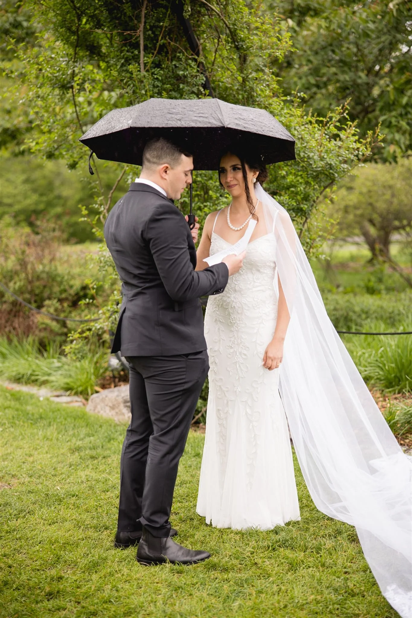 bride and groom exchanging their vows underneath an umbrella at Arnold's Arboretum in Jamaica Plains Boston