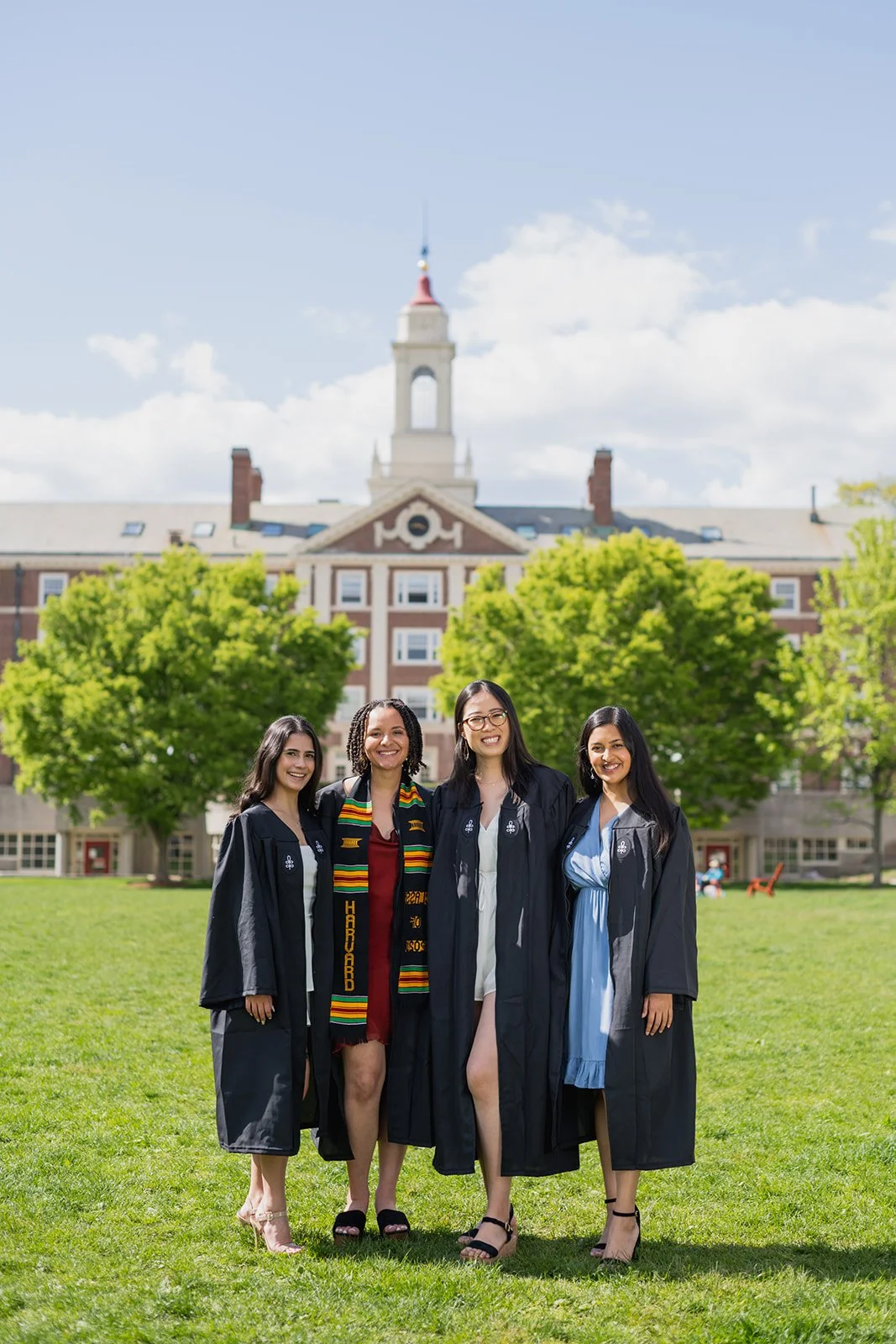 Group of graduates posing on the lawn at Harvard Yard during a graduation photography session in Boston