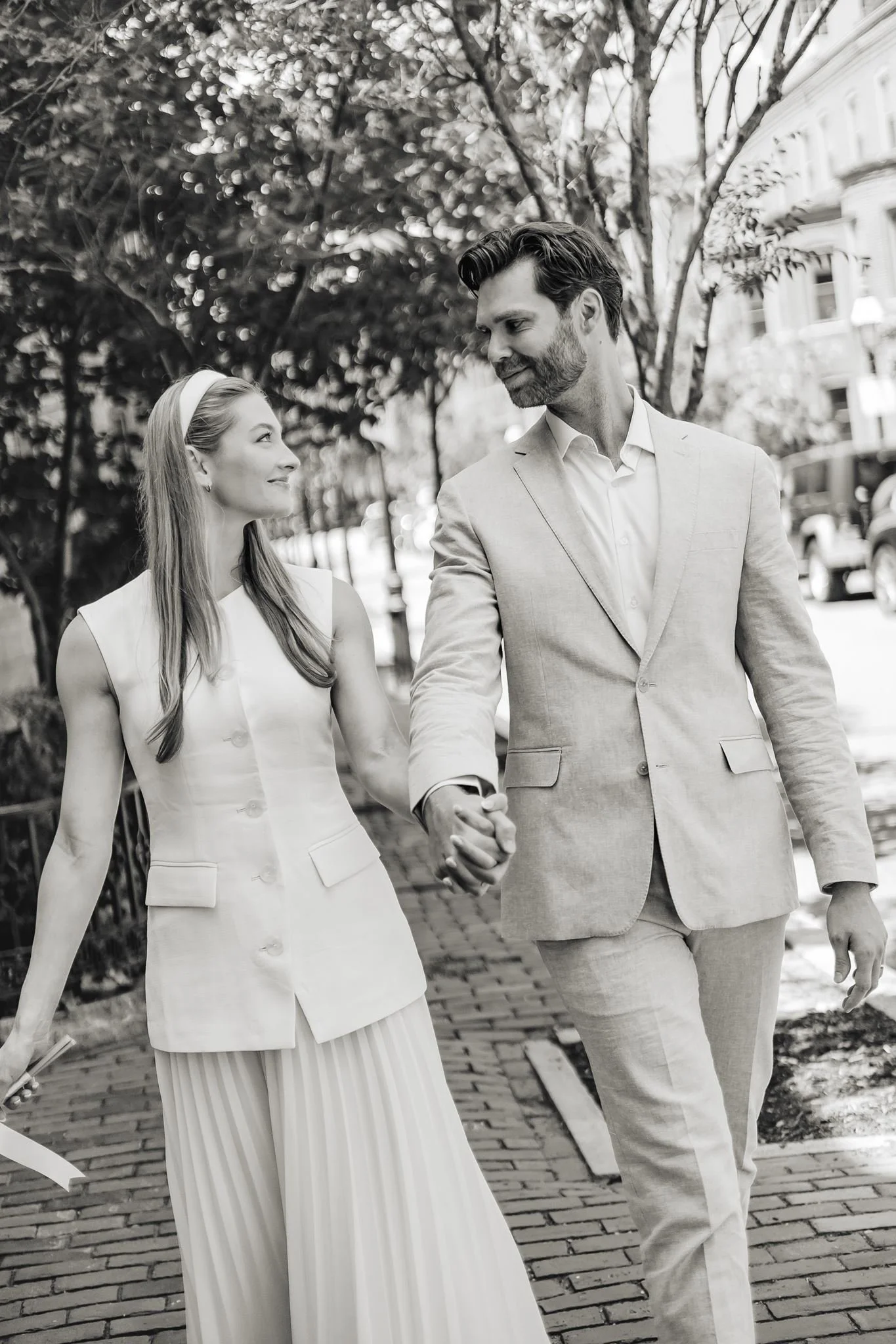 Newly married couple walking together after their Boston City Hall wedding.