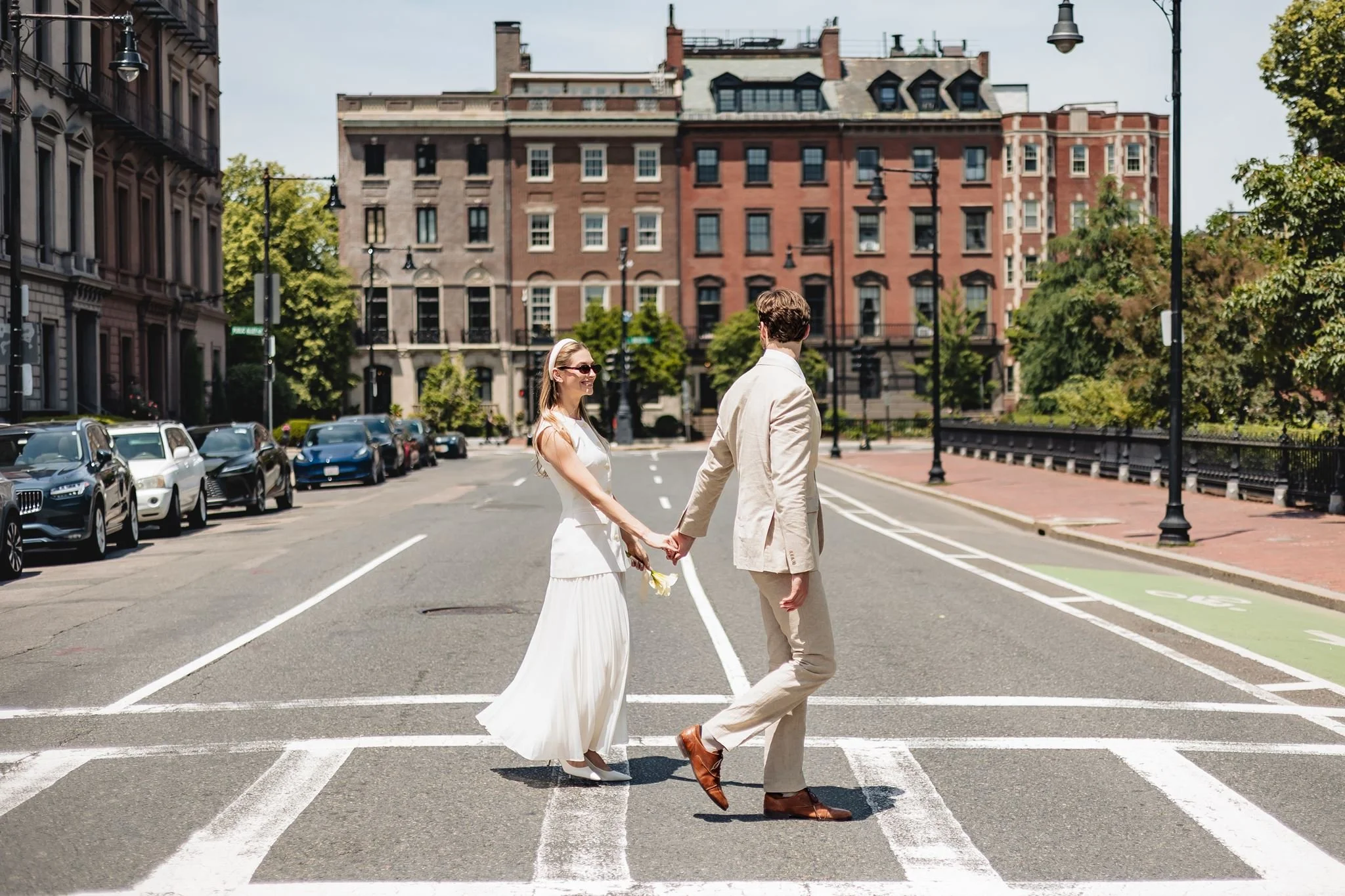 Newlyweds walking through downtown Boston following an intimate courthouse wedding.