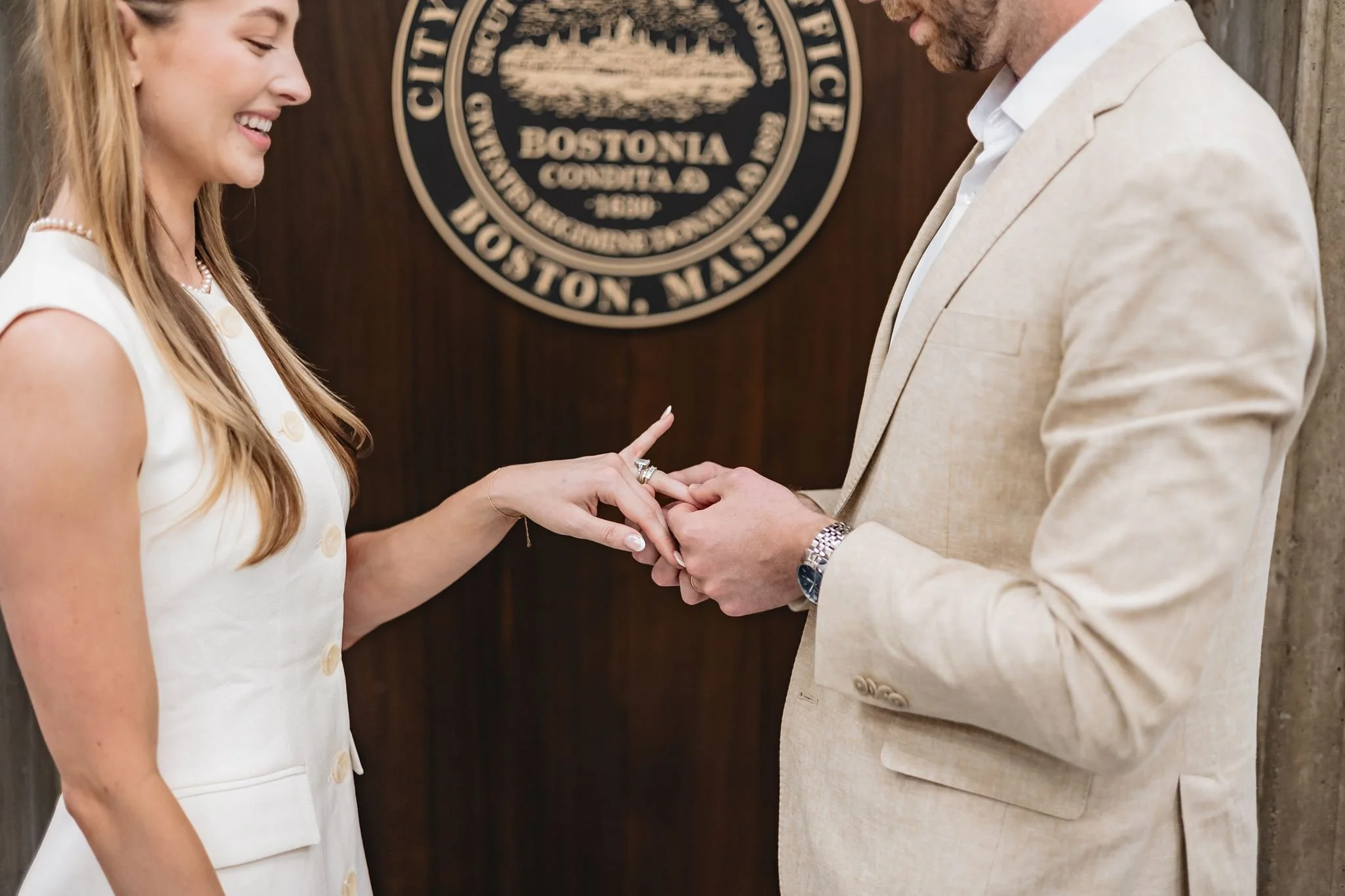 Bride and groom smiling after officially getting married at Boston City Hall.