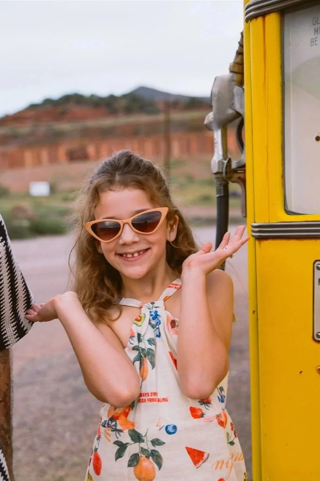 Storytelling family photo session at a historic Shell gas station in Bisbee, Arizona with a child posing next to a vintage gas pump