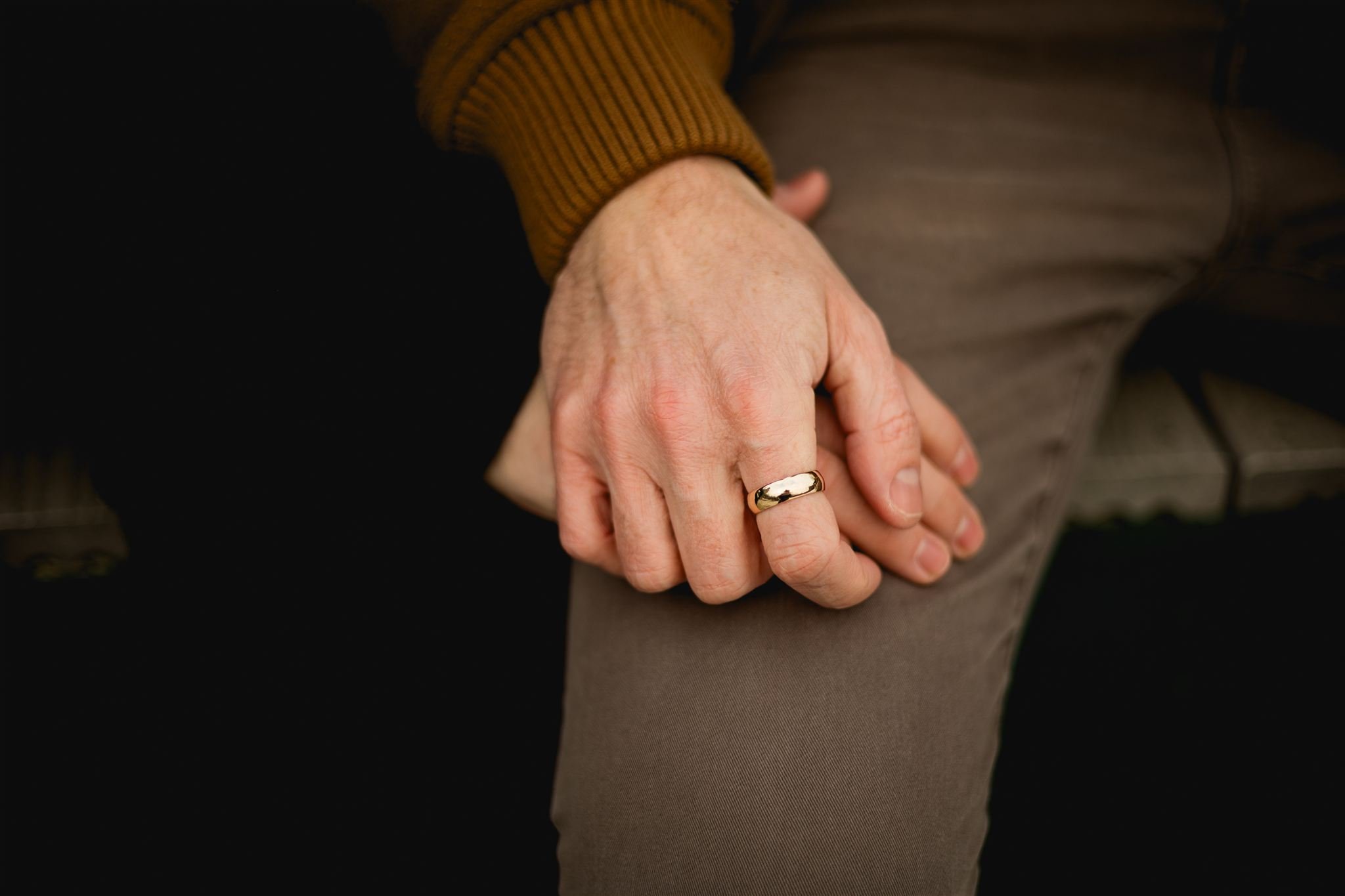 Close-up of engaged couple holding hands , showing thier engagement rings