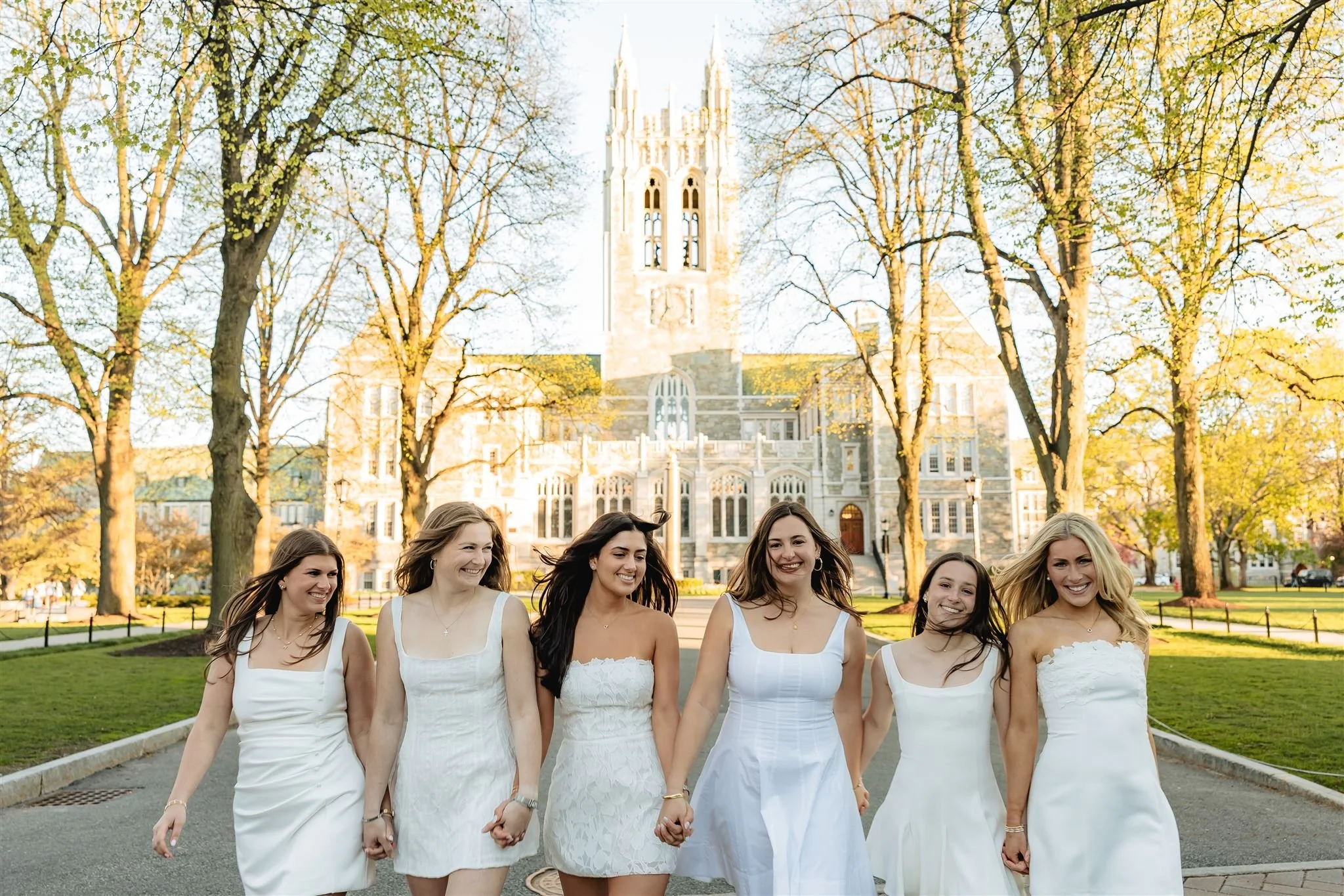 Friends laughing together during a college graduation photo shoot
