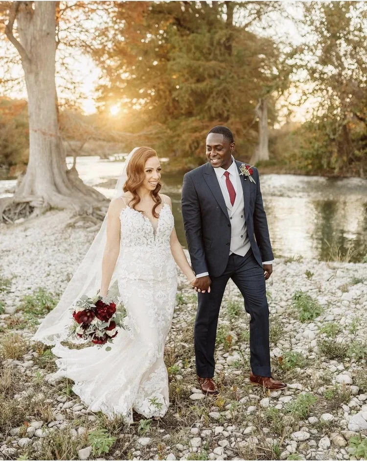 Couple walking together through the trees at golden hour