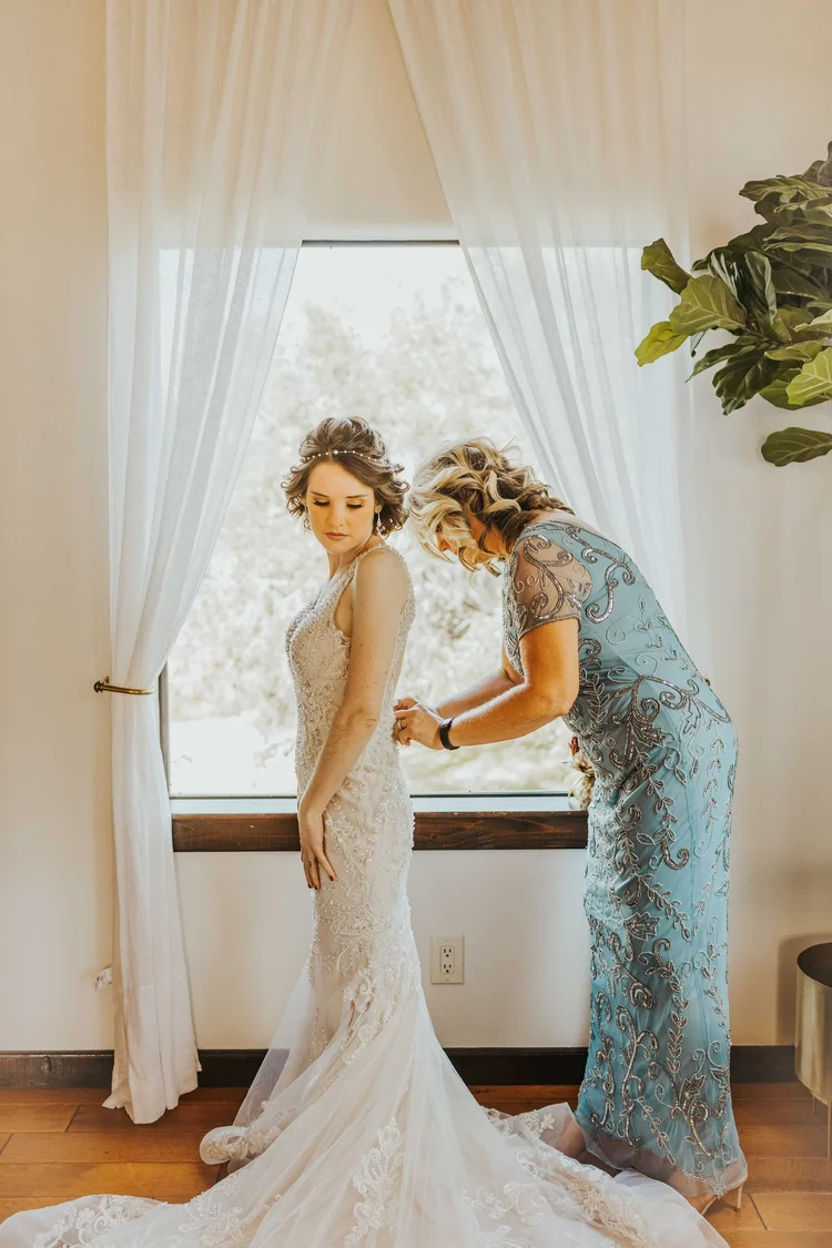 Bride getting ready with her mother in the bridal suite