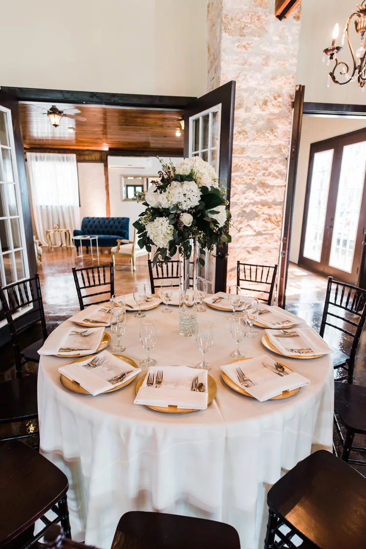 Reception tables set with linens, florals and candles