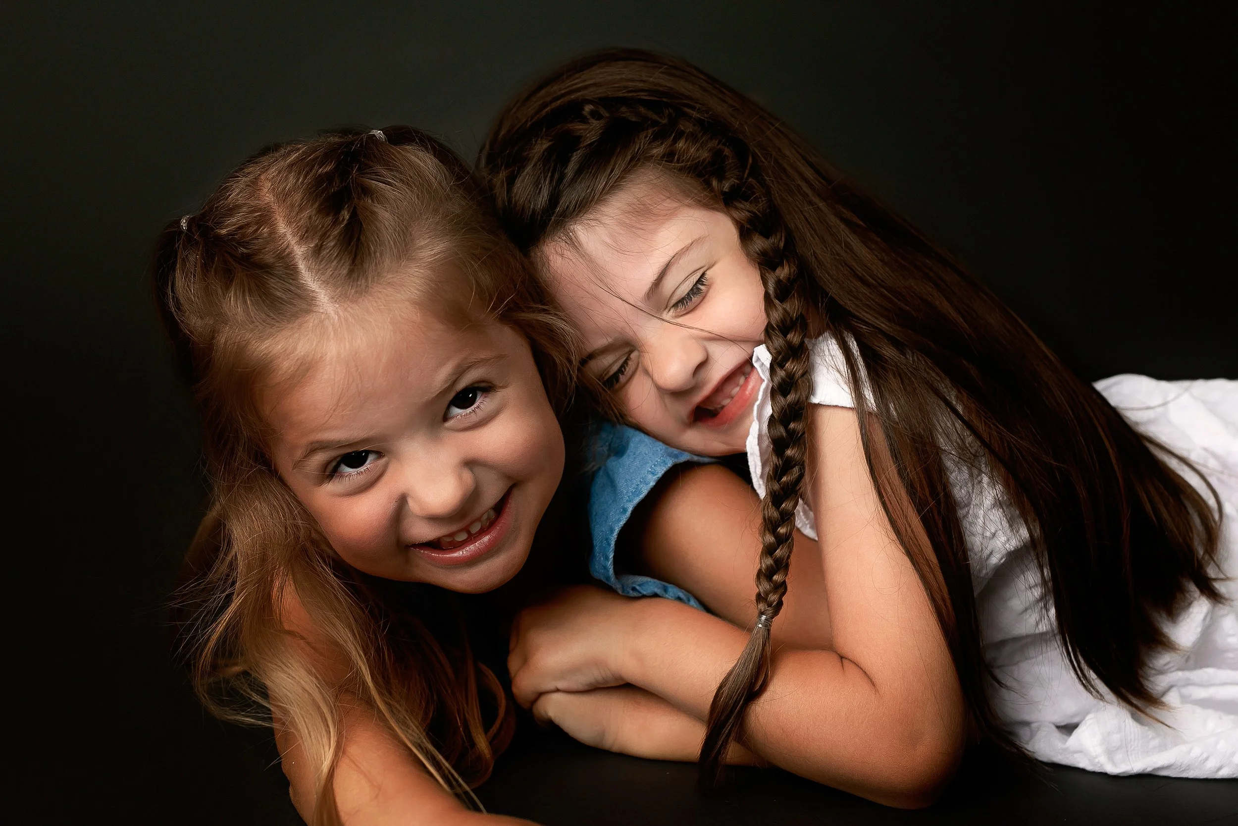 Twin sisters giggle and play during their Winchester VA Family Photography session with Worthy of Love Photographer a Winchester VA Photographer