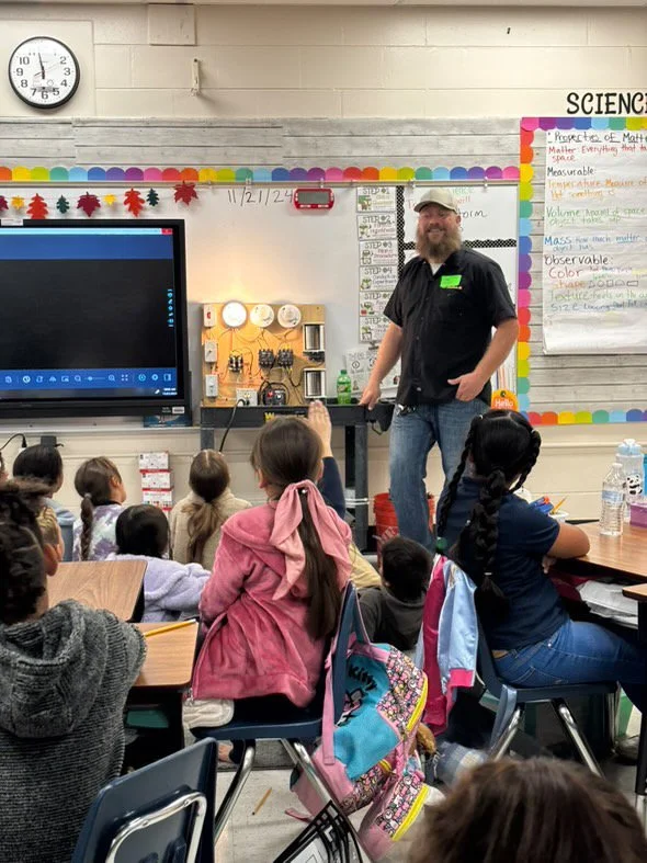 Stephen teaching kids at a school about lighting and electrical