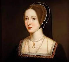 Portrait of a woman from the Renaissance era, wearing a dark dress with gold accents and jewelry, with her hair styled in an elaborate braided updo.