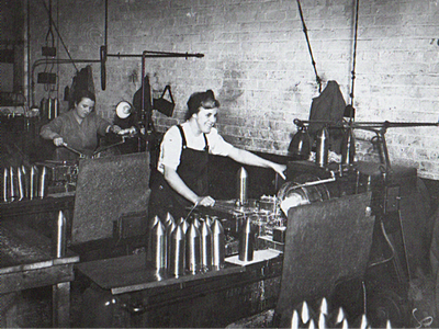 A photograph of a female munitions worker at work in a factory in Belfast during World War 2.