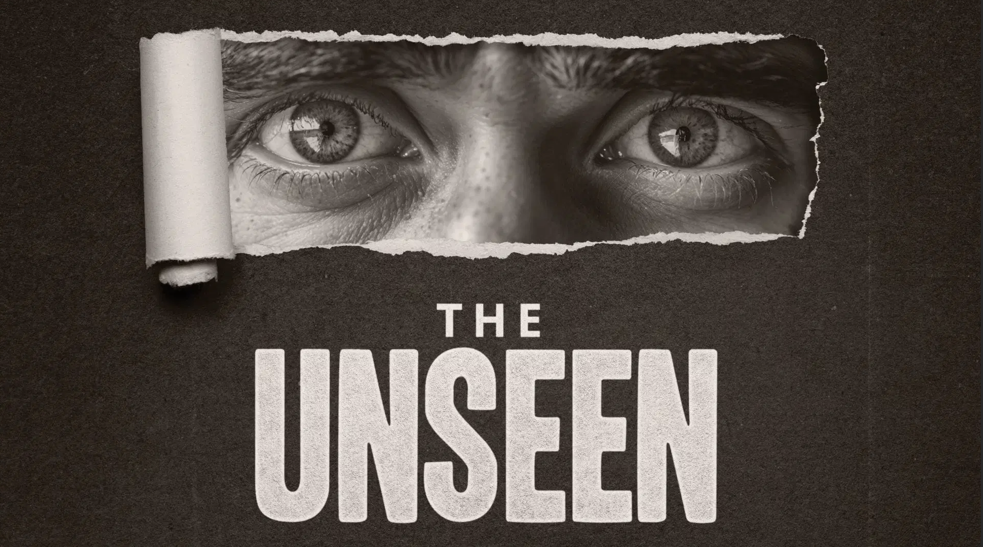 A black-and-white poster with a torn paper effect revealing a boy's eyes behind it, with the title 'The Unseen' in bold text below.